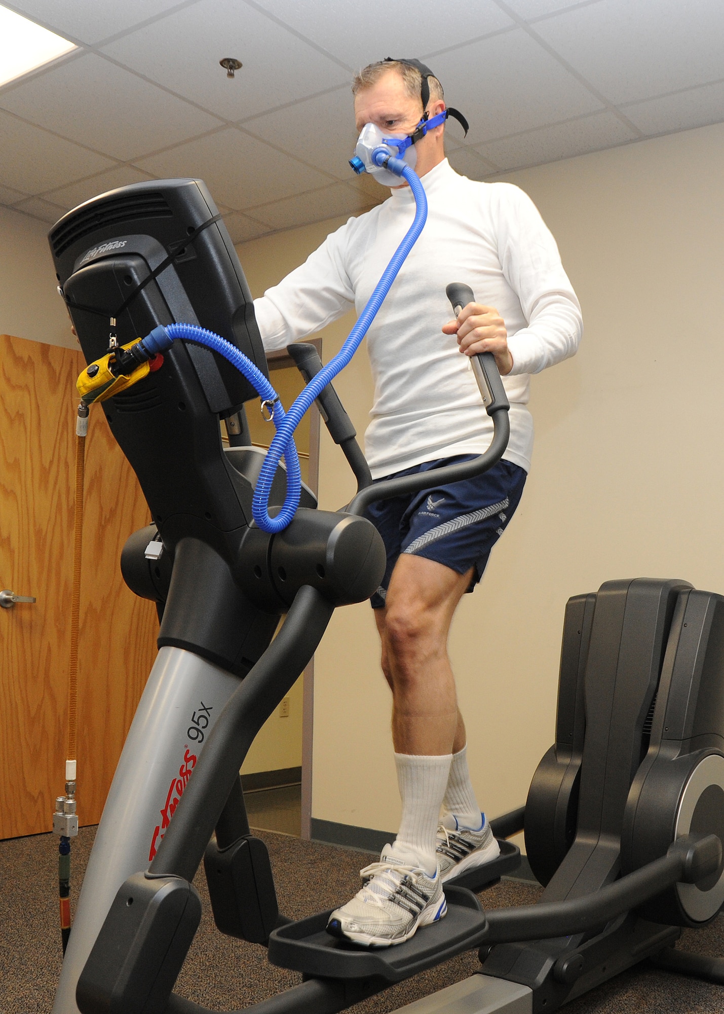 Gen. William M. Fraser III, commander of Air Combat Command, exercises on an elliptical machine at Beale Air Force Base, Calif., Jan. 10 prior to suiting up for a high-altitude chamber session. The 10-minute workout helps to expedite the removal of nitrogen in the body. (U.S. Air Force photo/9th Reconnaissance Wing Public Affairs)