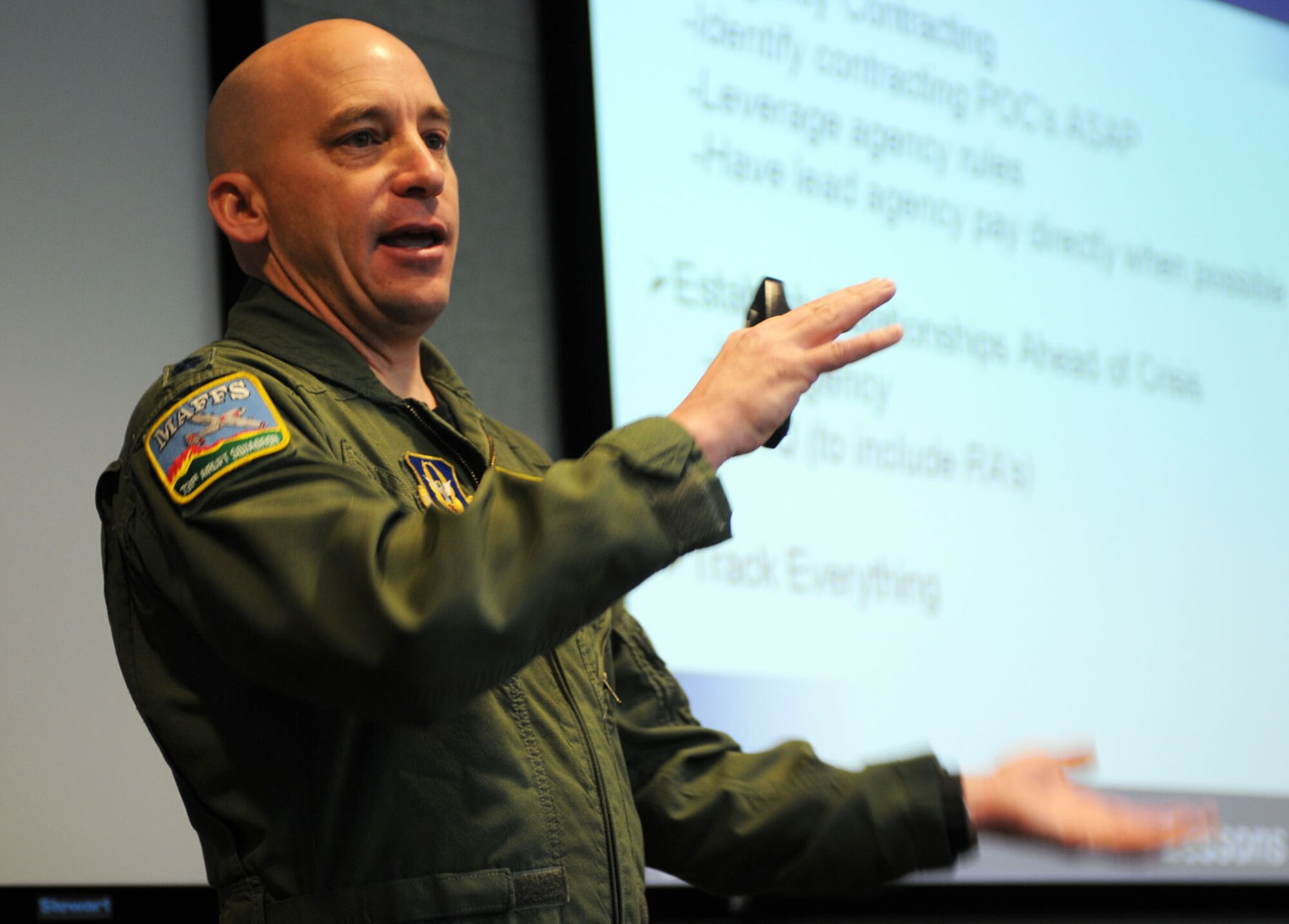 Lt. Col. David Condit, 302d Airlift Wing Chief of Safety and director of the 302d AW's aerial firefighting program, briefs  about 40 Airmen attending the the first ever Air Force Reserve Command C-130 Special Mission Conference at Peterson Air Force Base, Colo., Jan. 12-13. The conference was designed to share lessons learned, review policies and procedures, and tackle common support issues involved with the weather reconnaissance, aerial spray and aerial firefighting missions. (U.S. Air Force photo/Capt. Marnee A.C. Losurdo)  