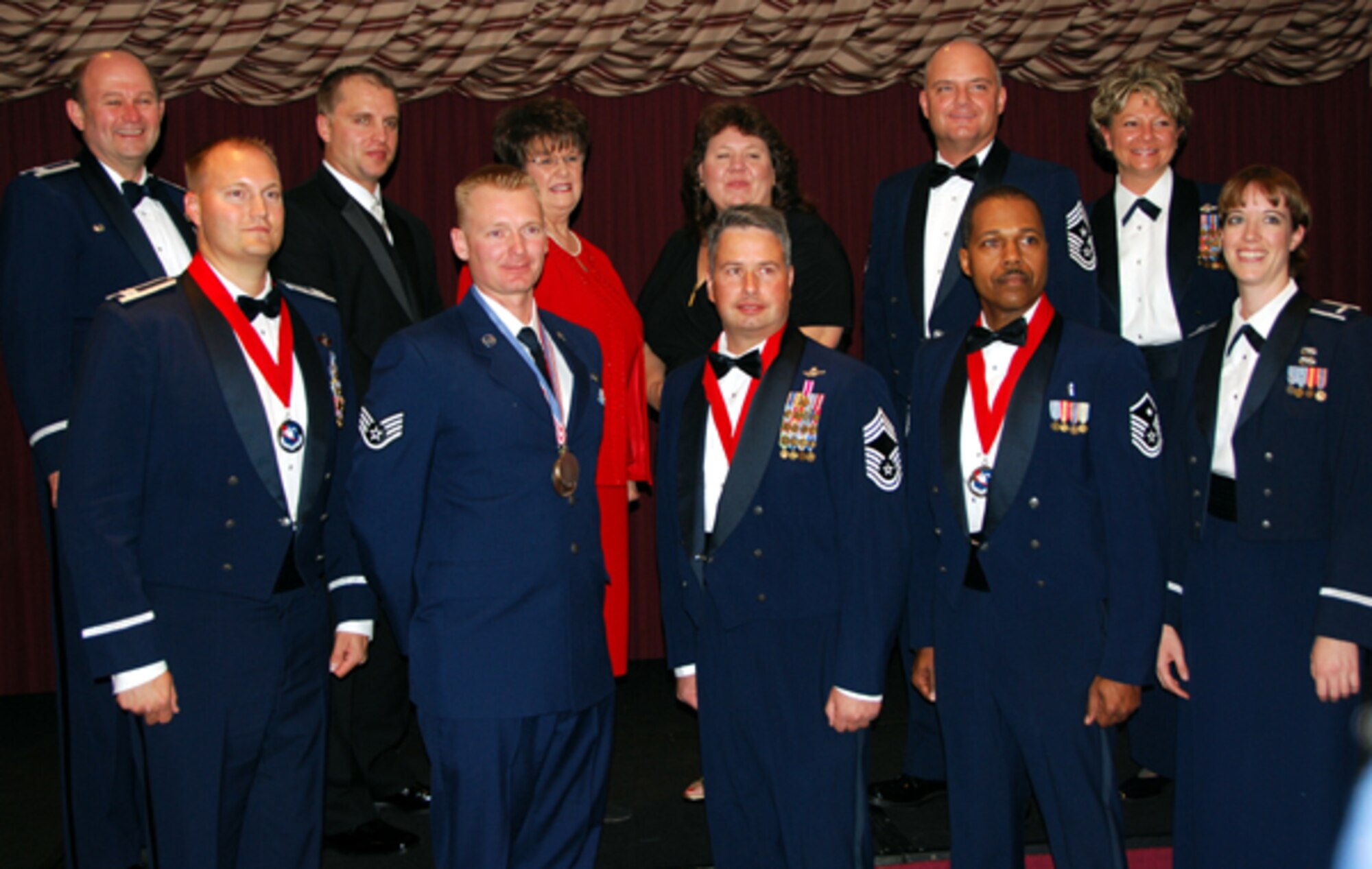 Attendees and award winners of the 507th Air Refueling Wing’s 2010 annual awards banquet pose for a group photo at the Tinker Club. FRONT ROW, LEFT TO RIGHT: Capt. Benjamin Yoder, 465th Aerial Refueling Squadron; Staff Sgt. Shawn Shaw, 507th Aircraft Maintenance Squadron; Chief Master Sgt. Phillip Brand, 507th Operations Group; Master Sgt. Phillip Baker, 507th Medical Squadron; and 1st Lt. Jacqueline Stauffer, 507th Logistics Readiness Squadron. BACK ROW, LEFT TO RIGHT: Col. Jeffery R. Glass, 507th Air Refueling Wing commander; Karl Wasserleben, manager of the Tinker Air Force Base branch of Tinker Federal Credit Union; Brenda Roberts, staff executive director of Moore, Okla., Chamber of Commerce; Jan Davis, branch manager of Tinker Federal Credit Union’s Moore branch; Command Chief Master Sgt. Dwight D. Badgett, command chief of Air Force Reserve Command; and Command Chief Master Sgt. Tina Long, 507 ARW command chief.