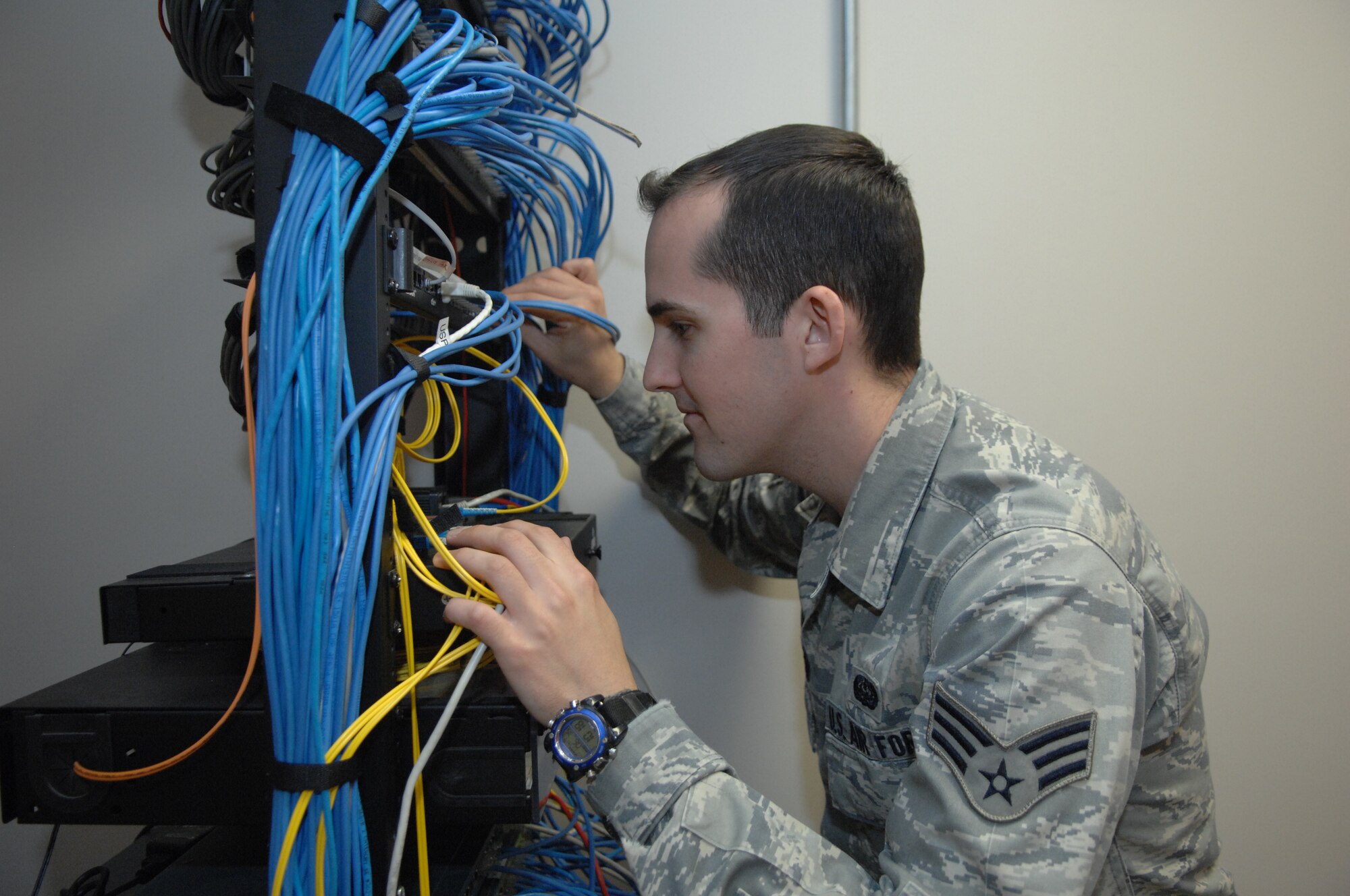 Senior Airman Dale Richardson, 43rd Communications Squadron, checks network wires for connectivity in the communications closet. During his deployment, Airman Richardson worked as a network administrator and a client system technician. (U.S. Air Force photo/Airman 1st Class Kate Wetherby)