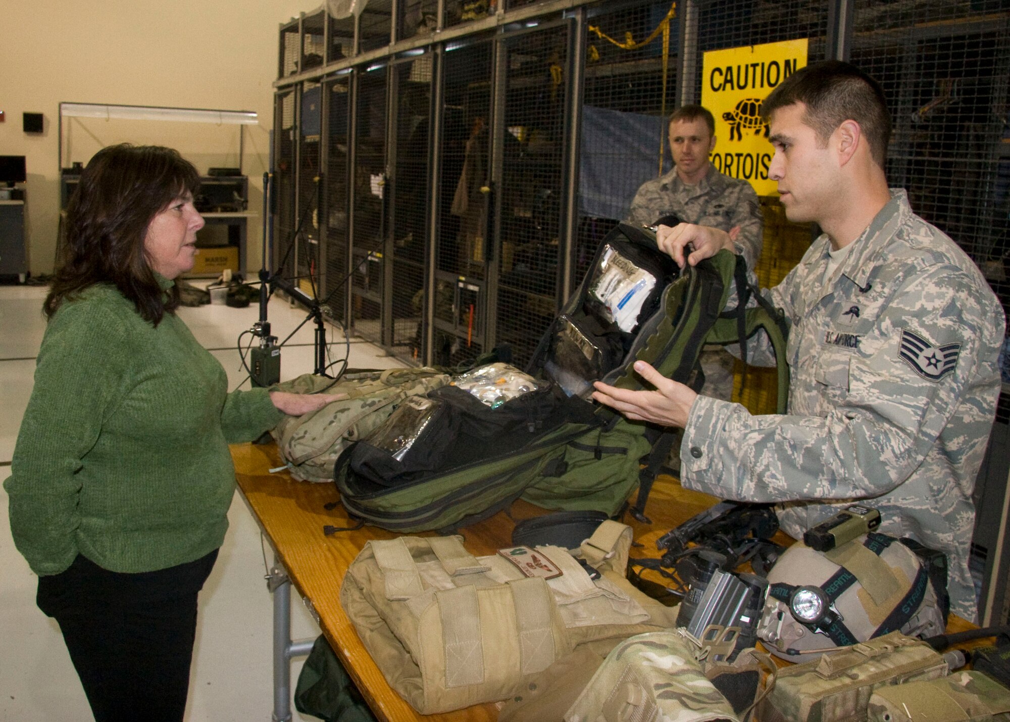 PORTLAND INTERNATIONAL AIRPORT, Ore. - Staff Sgt. Carl Jensen, 304th Rescue Squadron pararescueman, describes the contents of a pararescue medical kit to Oregon Sen. Martha Schrader (DEM) here January 9, 2011. Senator Schrader toured the Guardian Angel facilities and learned the general background of the 304th RQS and its accomplishments and attended a unit awards ceremony where she made a short speech. (U.S. Air Force Photo/Staff Sgt. Adam Hoffmann)