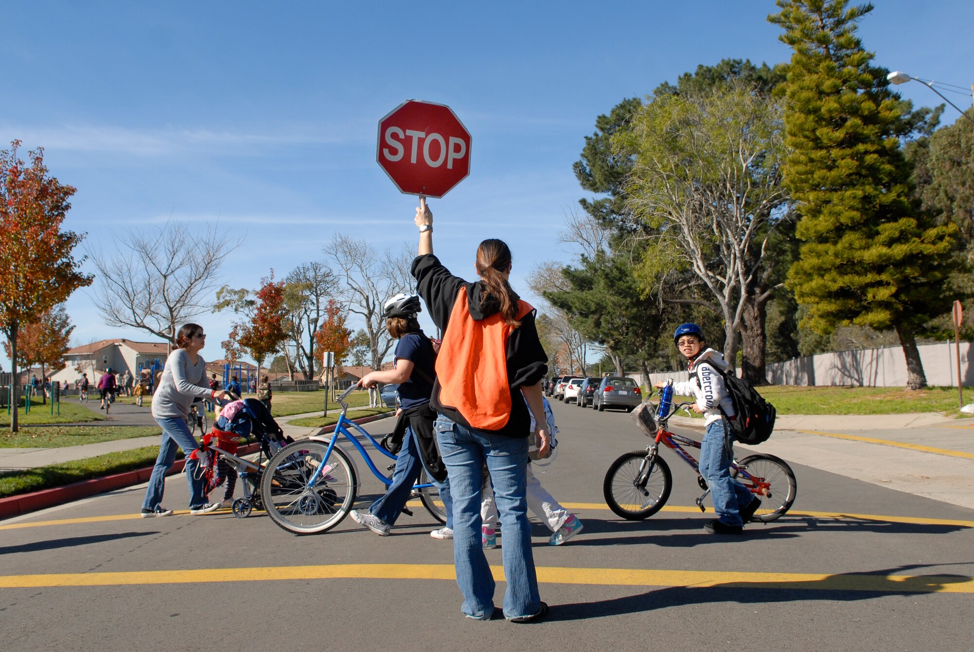 VANDENBERG AIR FORCE BASE, Calif. - Helping children safely cross the street, Tina Piche blocks traffic at an intersection next to the Crestview Elementary School here Wednesday, Jan. 12, 2011.  Team V members are reminded to drive with caution to keep Vandenberg personnel safe. (U.S. Air Force photo/Senior Airman Andrew Satran)  

