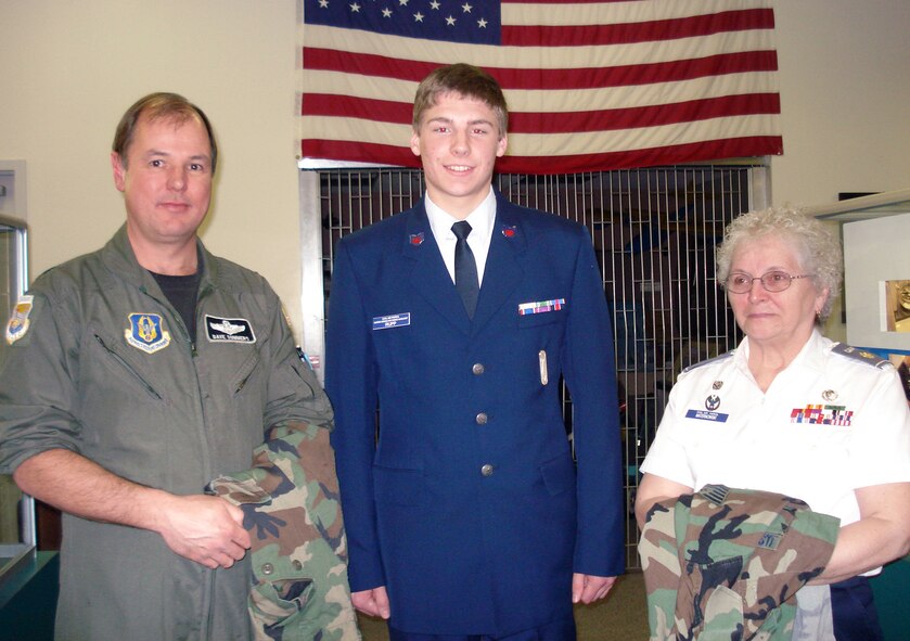 Lt. Col. Dave Sommers (left) delivers uniforms donated by Niagara Falls Air Reserve Station  Airmen to Civil Air Patrol members  Cadet Rupp and  squadron commander Maj. Ellen Maternowski  January 6, 2011  Jamestown, NY. (U.S. Air Force courtesy photo) 