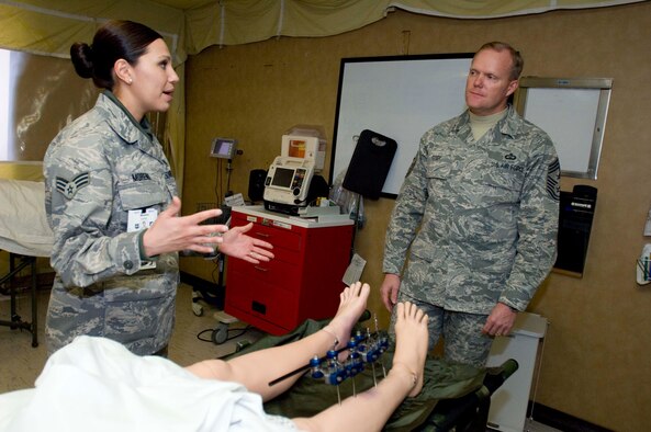 Senior Airman Cynthia Moreno, 59th Inpatient Operations Group medical technician (left), explains how she trains with mannequins to Chief Master Sgt. James Cody, Air Education and Training Command Chief, at Lackland Air Force Base, Texas, Jan. 12. Chief Cody spoke with 59th Medical Wing Airmen about their roles during his visit and recognized them for the challenges they face on an everyday basis. (U.S. Air Force photo/Senior Airman Corey Hook)










