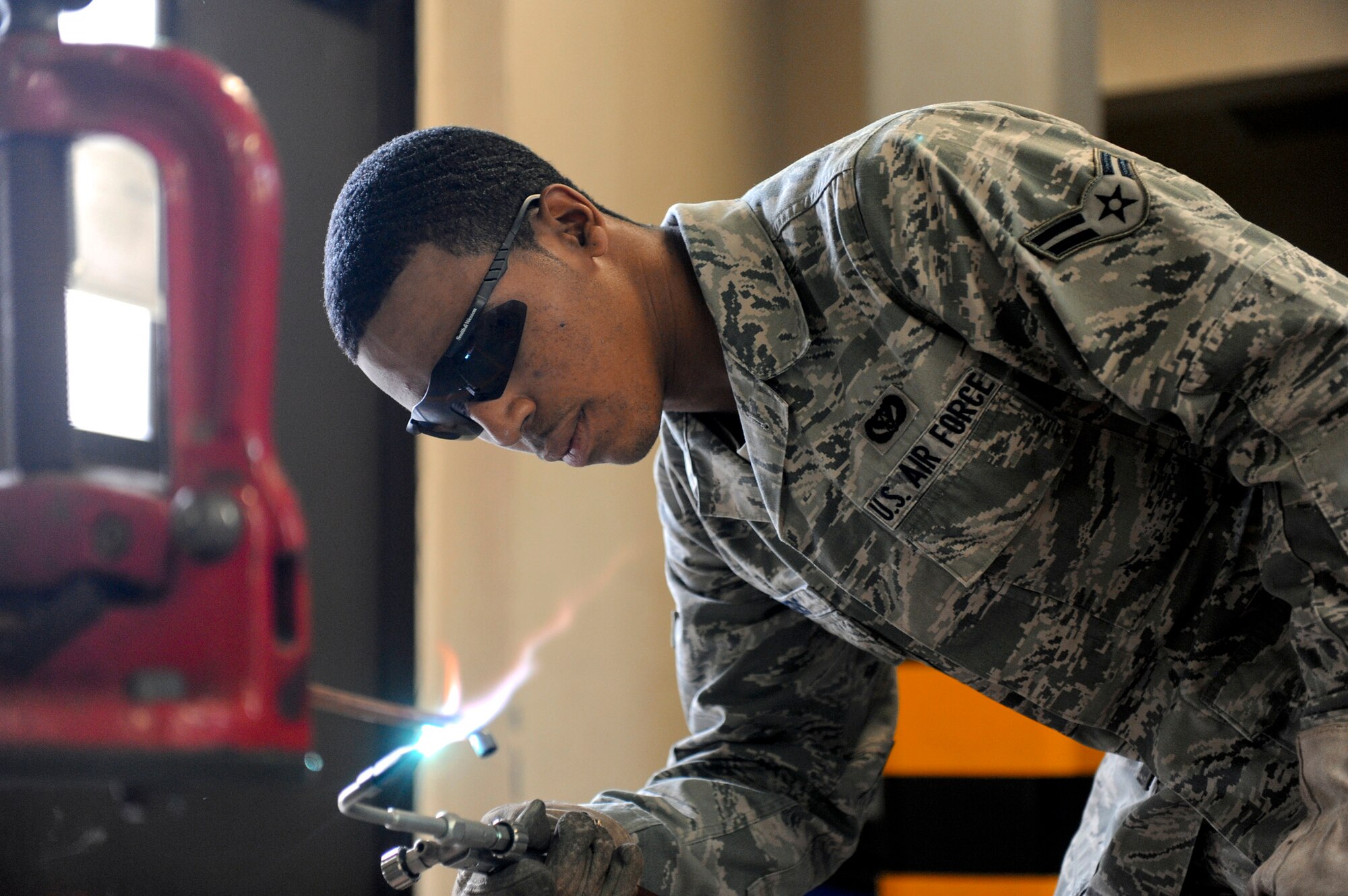 Airman 1st Class Terence Myers brazes a copper bypass line that will be installed into a liquid chiller Jan. 10, 2010, at a Navy communications facility. Airman Myers is a member of the 18th Civil Engineer Squadron's Operations Flight, which was recently awarded the 2010 Major General Clifton D. Wright Award for flight members' outstanding accomplishments in 2010. (U.S. Air Force photo/Staff Sgt. Jonathan Steffen) 