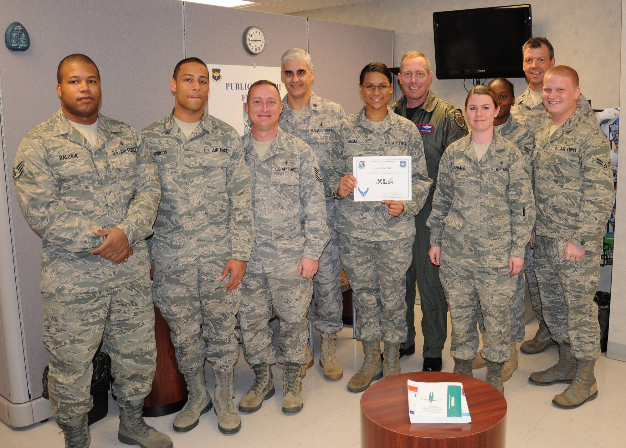 LAUGHLIN AIR FORCE BASE, Texas – Airman Chloe Ullah, 47th Medical Operations Squadron, poses with Col. Michael Frankel, 47th Flying Training Wing commander, and fellow members of her squadron after being presented the XLer of the Week award Jan. 12. The XLer is a weekly award chosen by wing leadership and given to individuals who consistently make outstanding contributions to Laughlin and their unit. (U.S. Air Force photo by Airman 1st Class Blake Mize)