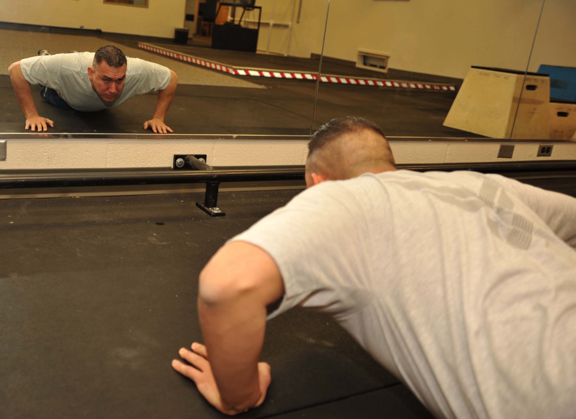 Capt. Robert Old Crow, 349th Air Refueling Squadron pilot and executive officer, observes his push-up form for accuracy Jan. 13, 2011, McConnell Air Force Base, Kan.  Captain Old Crow recently improved his fitness score, earning a 97.3 on his most recent physical fitness test.  (U.S. Air Force photo/Senior Airman Abigail Klein)