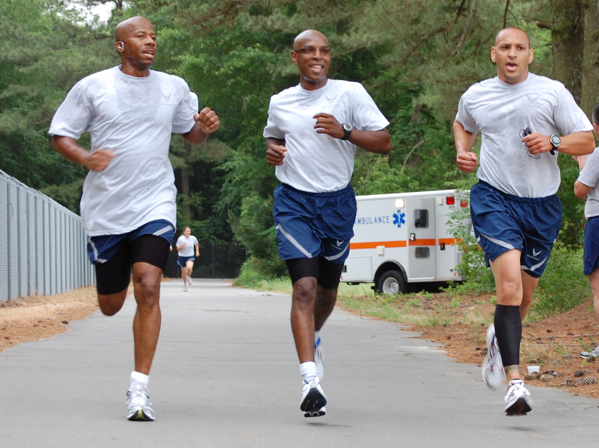 Senior Master Sgt. Terry McCabe (center), runs with Maj. Jeff Prindle (right) and Chief Gordan Caviness of 916th Security Forces. Sergeant McCabe was one of eight Airmen associated with the 916th to earn a perfect score on the new fit to fight test in 2010. (USAF courtesy photo)