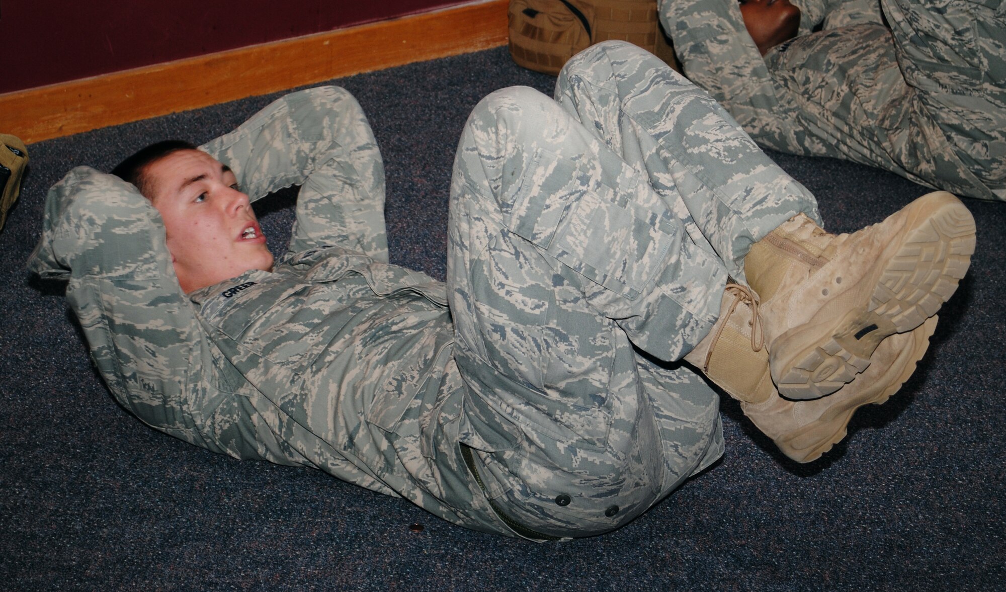 Airman 1st Class Steven Greer, a 341st Security Forces Group Tactical Response Force member, knocks out some crunches during a mid-day PT session.  As part of a team on alert status, he participates in various PT sessions throughout the entire day. (U.S. Air Force photo/Airman Cortney Hansen)