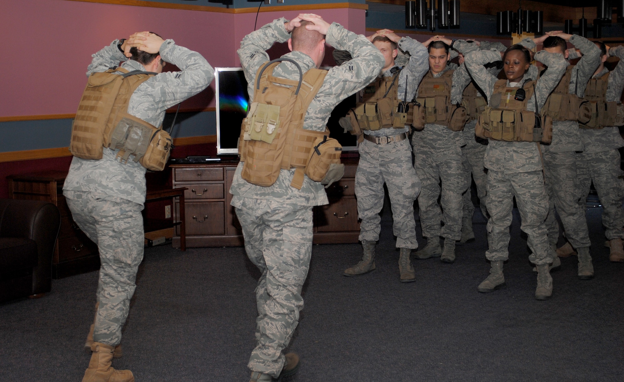 Members of the 341st Security Forces Group Tactical Response Force take turns doing walking lunges with partners.  Most of the exercises TRF members do are with partners to encourage teamwork. (U.S. Air Force photo/Airman Cortney Hansen)