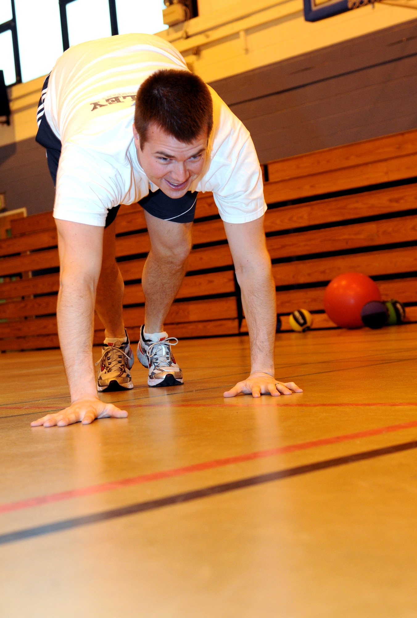 RAF MILDENHALL, England -- Capt. Tyler Berge, 100th Operations Support Squadron Wing Scheduling chief of current operations, warms up before a High Intensity Interval training class here Jan. 13, 2011.  Captain Berge is participating in the Biggest Loser competition.  His goals are to lose 25 pounds and to make better than a 95 percent pass rate on his next physical training test. (U.S. Air Force photo/Senior Airman Tabitha M. Lee)