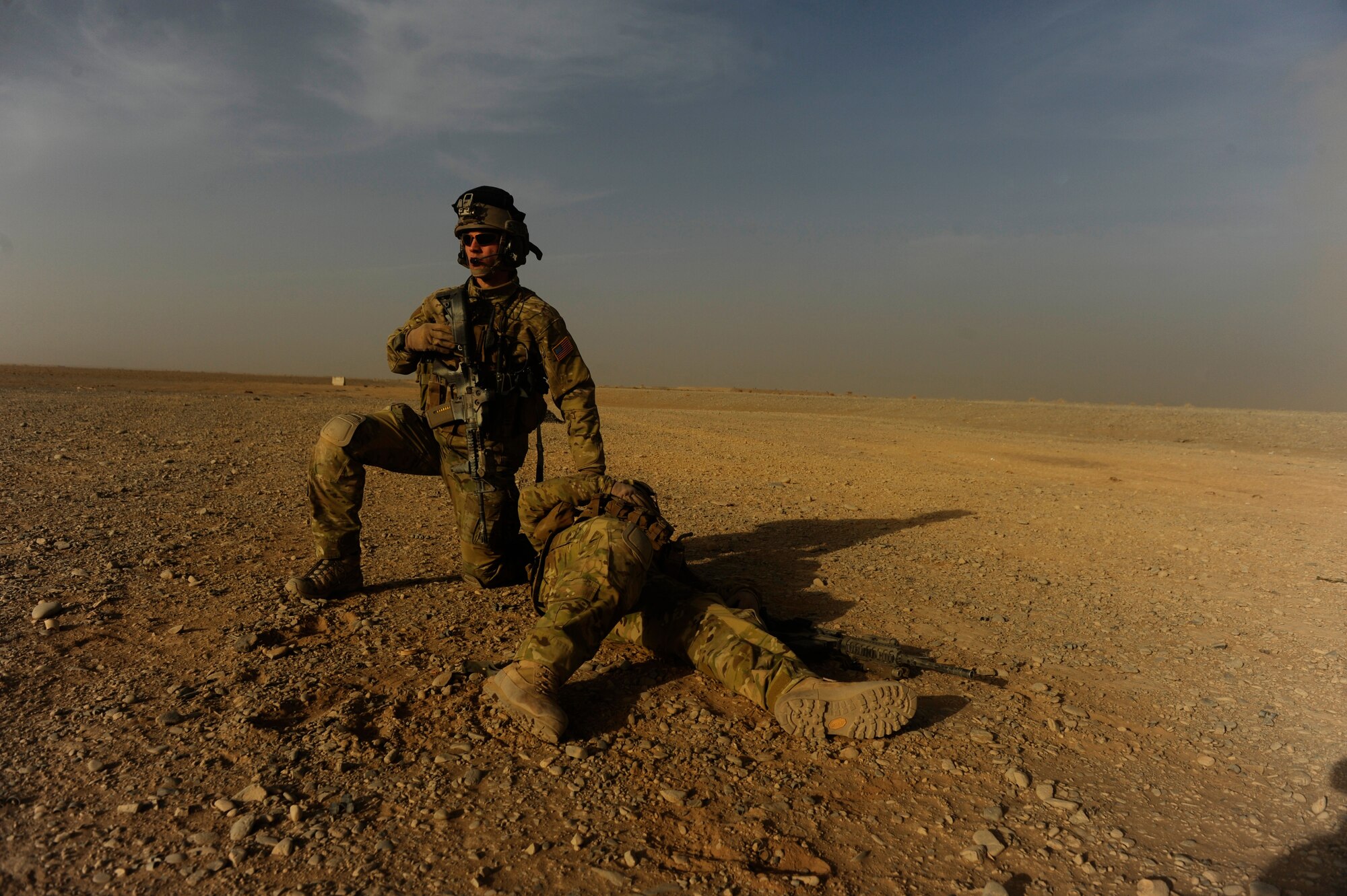 Captain Nick Morgans, 46th Expeditionary Rescue Squadron, protects a simulated casualty while awaiting pickup during a mass casualty scenario near Kandahar, Afghanistan, Dec. 24, 2010.  The scenario was planned as part of Tech. Sgt. Anthony Wood's qualification to become an element leader.  (U.S. Air Force Photo/Staff Sgt. Eric Harris) (RELEASED)