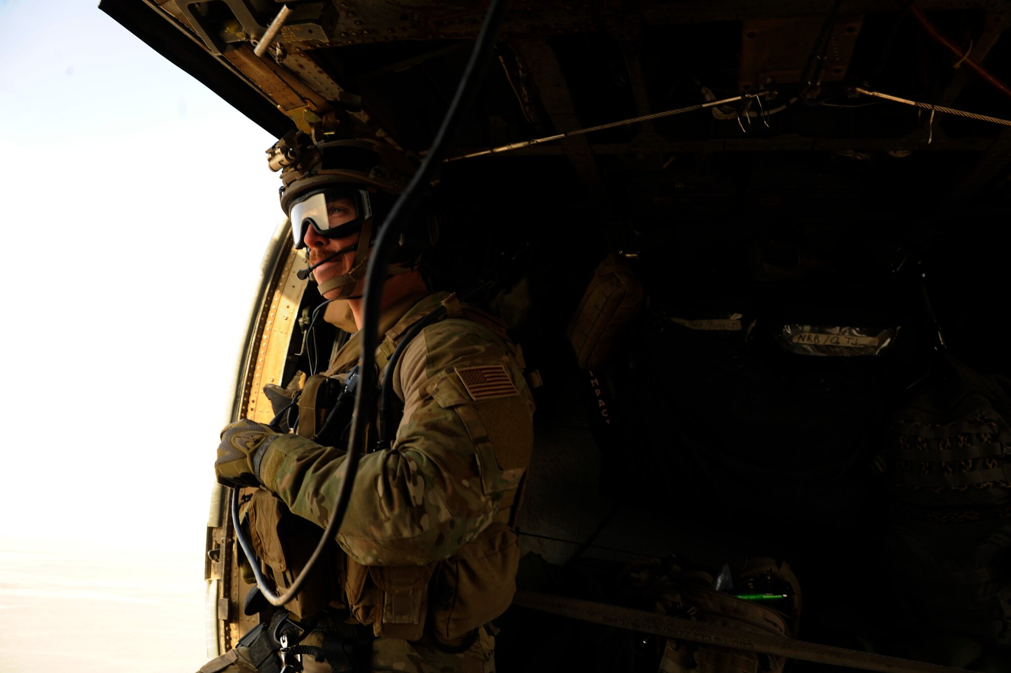 Staff Sgt. Kip Aussant, 46th Expeditionary Rescue Squadron, scans his sector on the way to a landing zone during a mission in support of Operation Endering Freedom aboard an HH-60 Pave Hawk near Kandahar, Afghanistan, Dec. 24, 2010.  A pararescueman's primary function is as a personnel recovery specialist with emergency medical capabilities in humanitarian and combat environments.  (U.S. Air Force Photo/Staff Sgt. Eric Harris) (RELEASED)