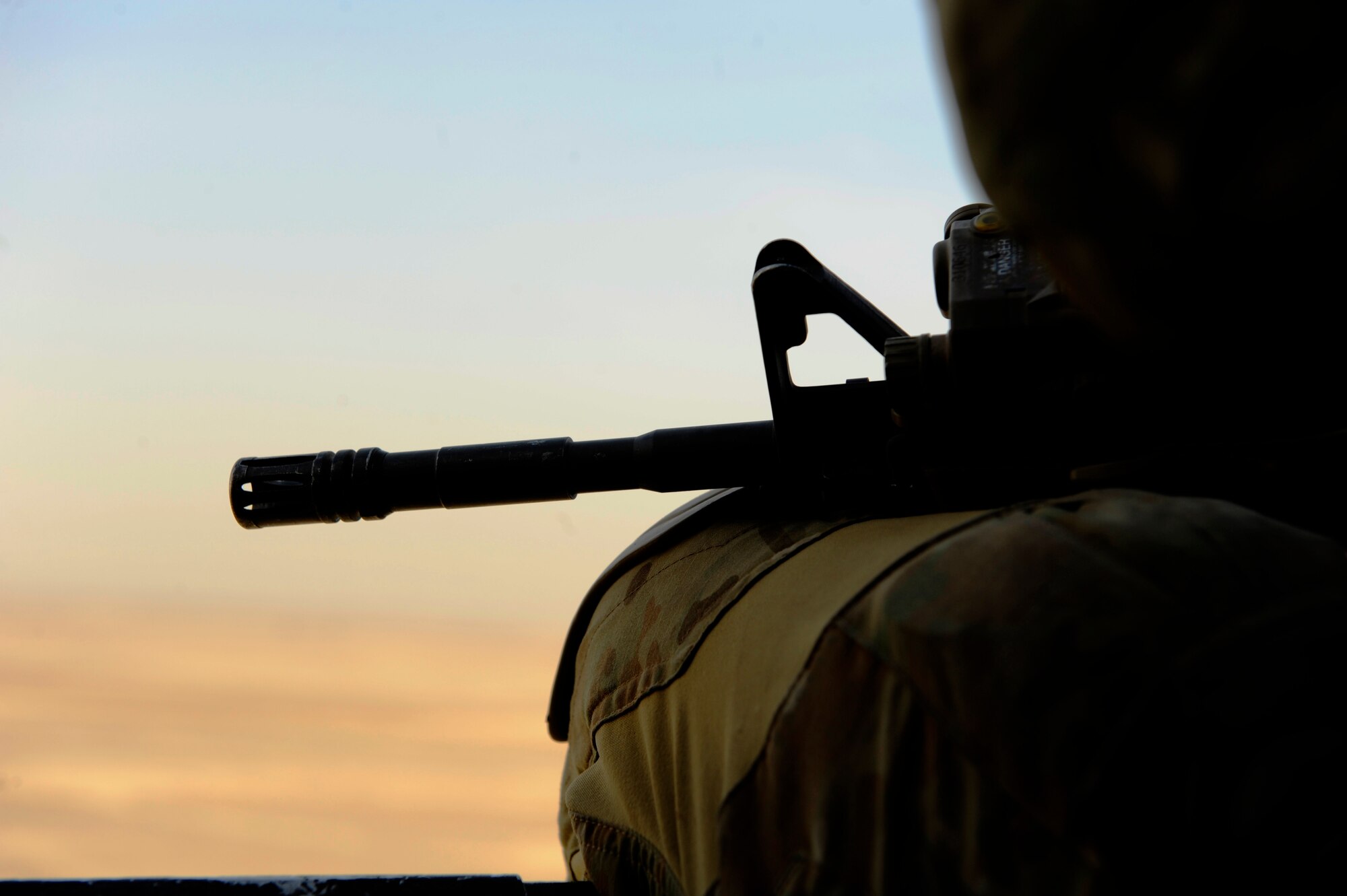 Staff Sgt. Kip Aussant, 46th Expeditionary Rescue Squadron, scans his sector on the way to a landing zone during a mission in support of Operation Enduring Freedom aboard an HH-60 Pave Hawk near Kandahar, Afghanistan, Dec. 24, 2010.  A pararescueman's primary function is as a personnel recovery specialist with emergency medical capabilities in humanitarian and combat environments.  (U.S. Air Force Photo/Staff Sgt. Eric Harris) (RELEASED)