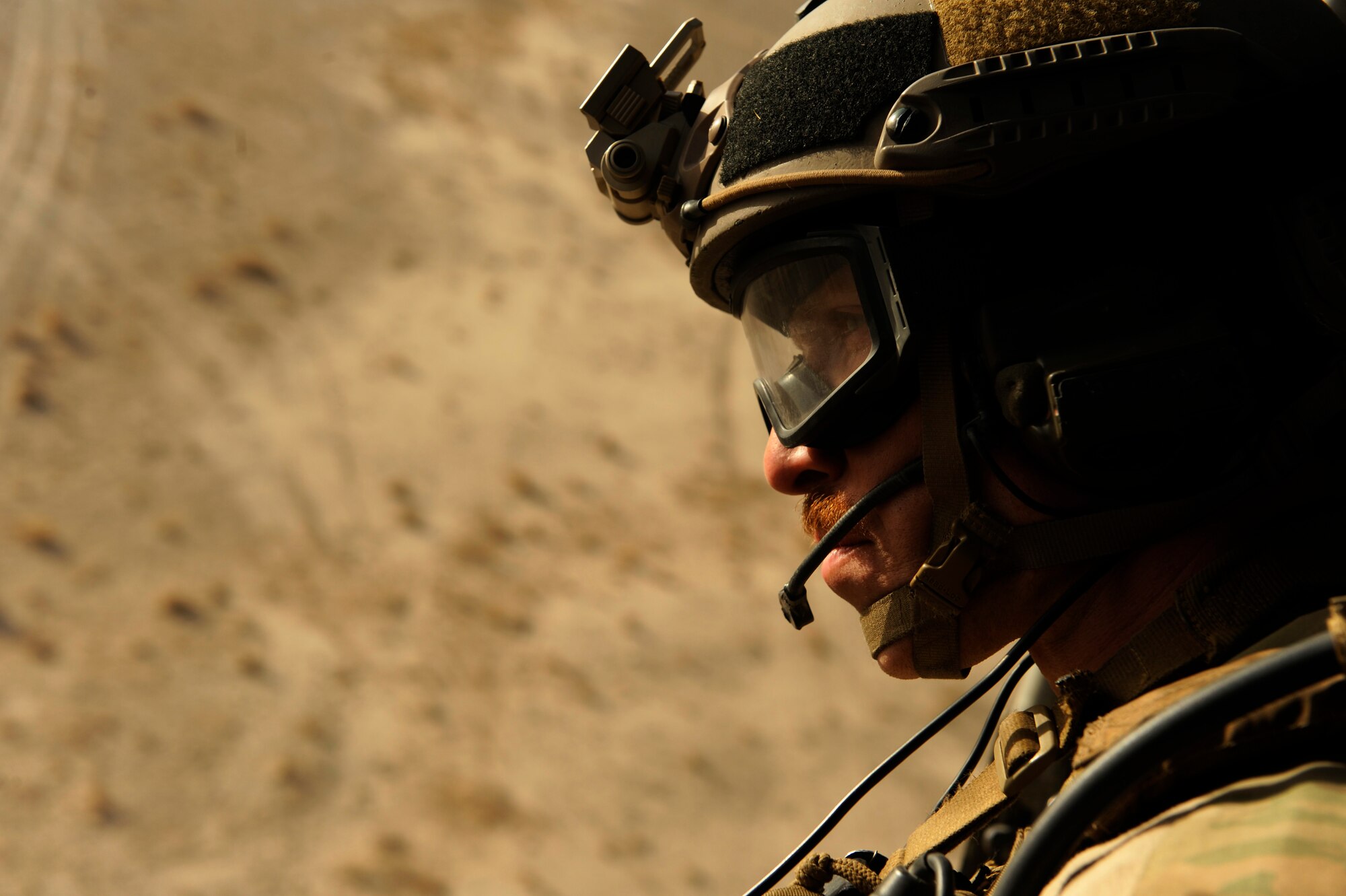 Staff Sgt. Kip Aussant, 46th Expeditionary Rescue Squadron, scans his sector on the way to a landing zone during a mission in support of Operation Endering Freedom aboard an HH-60 Pave Hawk near Kandahar, Afghanistan, Dec. 24, 2010.  A pararescueman's primary function is as a personnel recovery specialist with emergency medical capabilities in humanitarian and combat environments.  (U.S. Air Force Photo/Staff Sgt. Eric Harris) (RELEASED)
