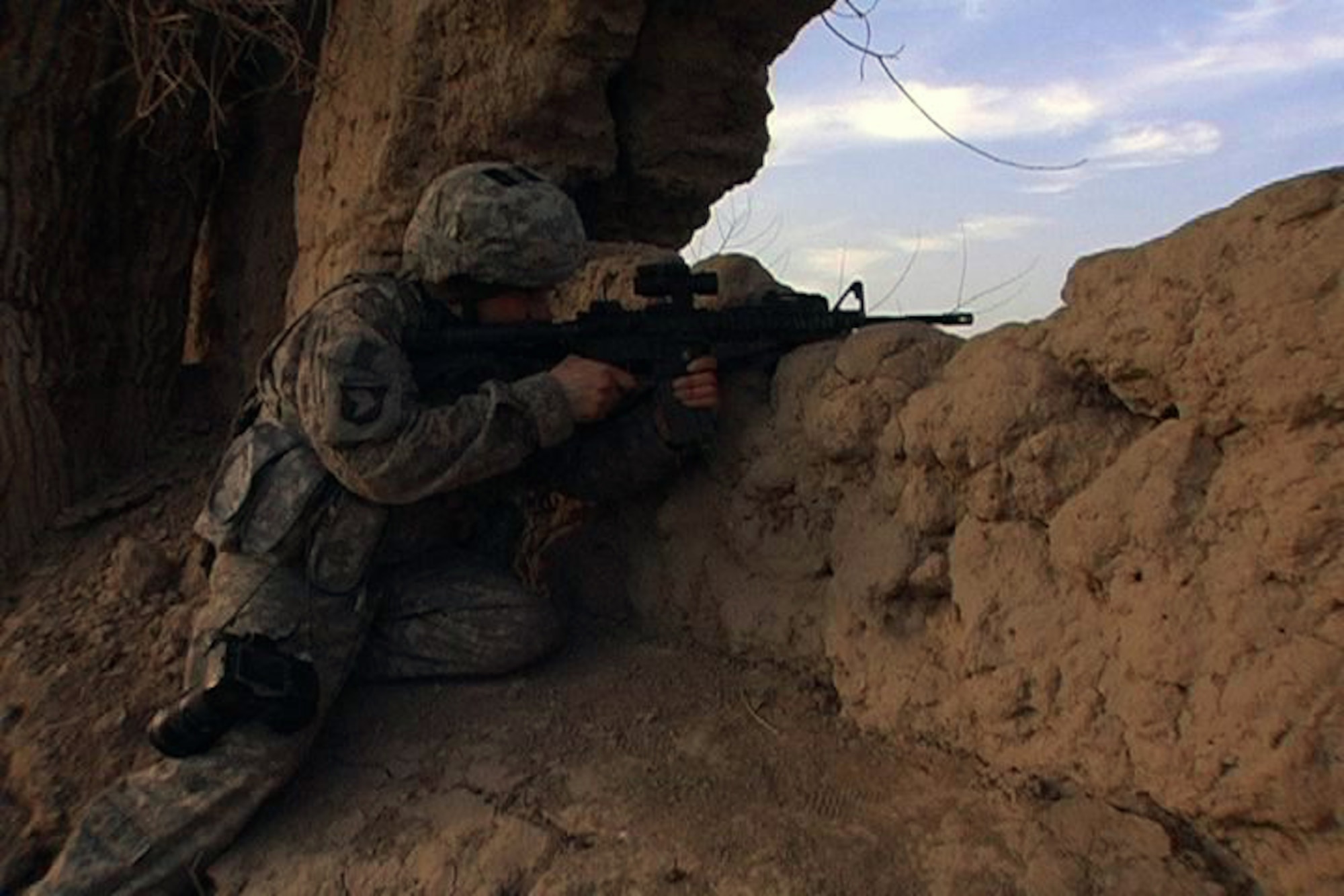 U.S. Air Force Tech. Sgt. Kevin Wallace, Regional Command-West Media Combat Team photojournalist, pulls security in a cleared compound in southern Bala Murghab Valley, near Combat Outpost Delorean, Bala Murghab, Baghdis Province, Afghanistan Jan. 9, 2011.  Sergeant Wallace's team came under accurate small-arms fire while on a reconnaissance foot patrol in the area. The photojournalist is deployed from the 100th Air Refueling Wing at Royal Air Force Mildenhall, England. (U.S. Navy photo/Mass Communications Specialist 1st Class John Pearl)