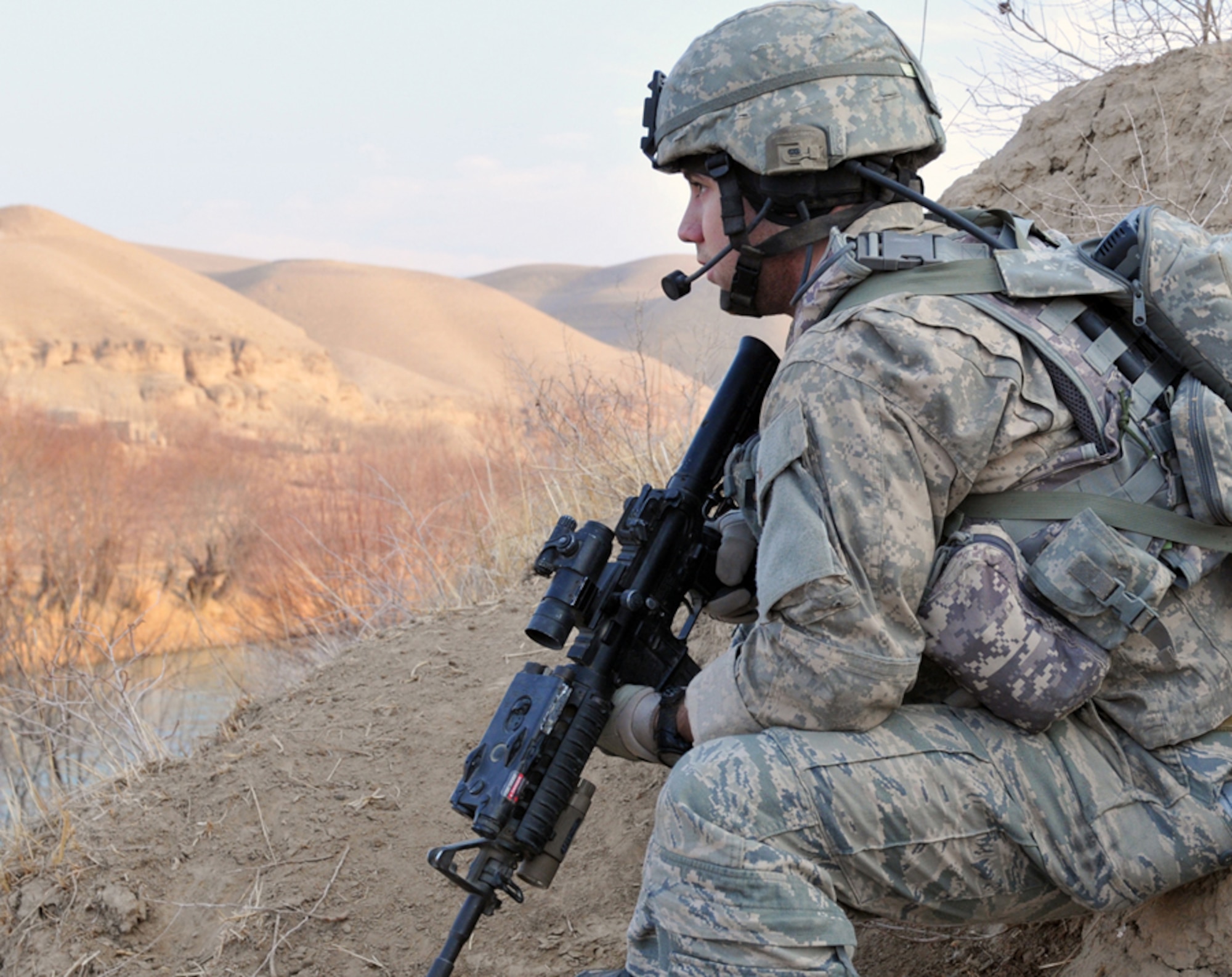 U.S. Air Force Senior Airman Jeremy Knox, Tactical Air Control Party deployed with Bulldog Troop, 7th Squadron, 10th Cavalry Regiment, secures a sector of fire on a riverbed near Combat Outpost Delorean, Bala Murghab, Baghdis Province, Afghanistan Jan. 9, 2011. Airman Knox hails from Anderson, Ind., and was one of two Tactical-Party Airmen on the patrol. (U.S. Air Force photo/Tech. Sgt. Kevin Wallace)