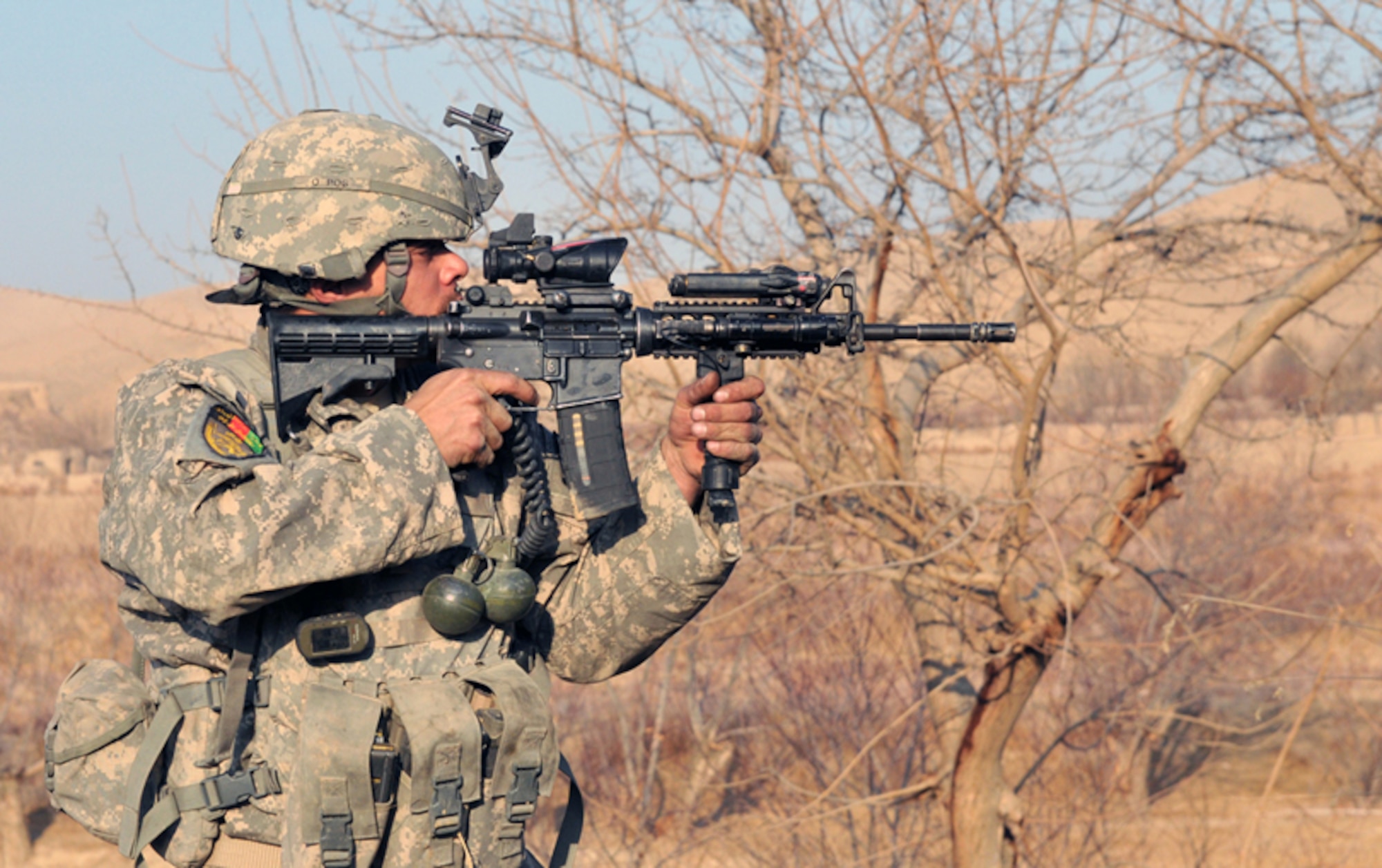U.S. Army Staff Sgt. Nicholas Lewis, Bulldog Troop, White Platoon, returns fire near Combat Outpost Delorean, Bala Murghab, Baghdis Province, Afghanistan Jan. 9, 2011. Sergeant Lewis led one of the four fire teams on the patrol and all four teams came under accurate small-arms fire. Insurgents also launched a large-scale attack on COP Delorean Jan. 6 from this field and two other areas. The Soldiers patrolled to reconnaissance the area and search for evidence.  (U.S. Air Force photo/Tech. Sgt. Kevin Wallace)     