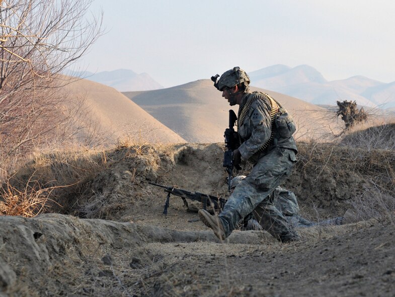 White Platoon, Bulldog Troop Soldiers take cover as they receive accurate small-arms fire on a riverbed near Combat Outpost Delorean, Bala Murghab, Baghdis Province, Afghanistan Jan. 9, 2011. The patrol consisted of Soldiers deployed from 1st Brigade, 4th Infantry Division out of Fort Carson, Colo., Afghan National Army soldiers from Bala Murghab, two Tactical Air Control Party Airmen from Fort Hood, Texas, and Fort Bragg, N.C., a Navy Reserve videographer, and an Air Force photojournalist from Royal Air Force Mildenhall, England. (U.S. Air Force photo/Tech. Sgt. Kevin Wallace)