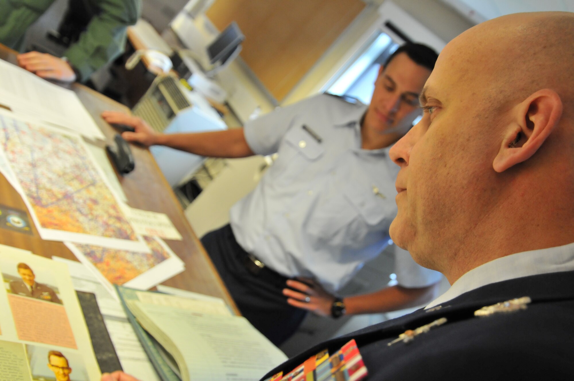 ROYAL AIR FORCE COTTESMORE, England -- Master Sgt. Louis Distelzweig, a pararescueman with the 56th Rescue Squadron at RAF Lakenheath, looks at a picture of his father, Capt. Louis Distelzweig Jr., in an album at the Royal Air Force’s No. 1 Squadron, Jan. 11. Sergeant Distelzweig visited RAF Cottesmore to view the Harrier aircraft his father flew in the 1970 as an exchange pilot. (U.S. Air Force photo/Senior Airman David Dobrydney)