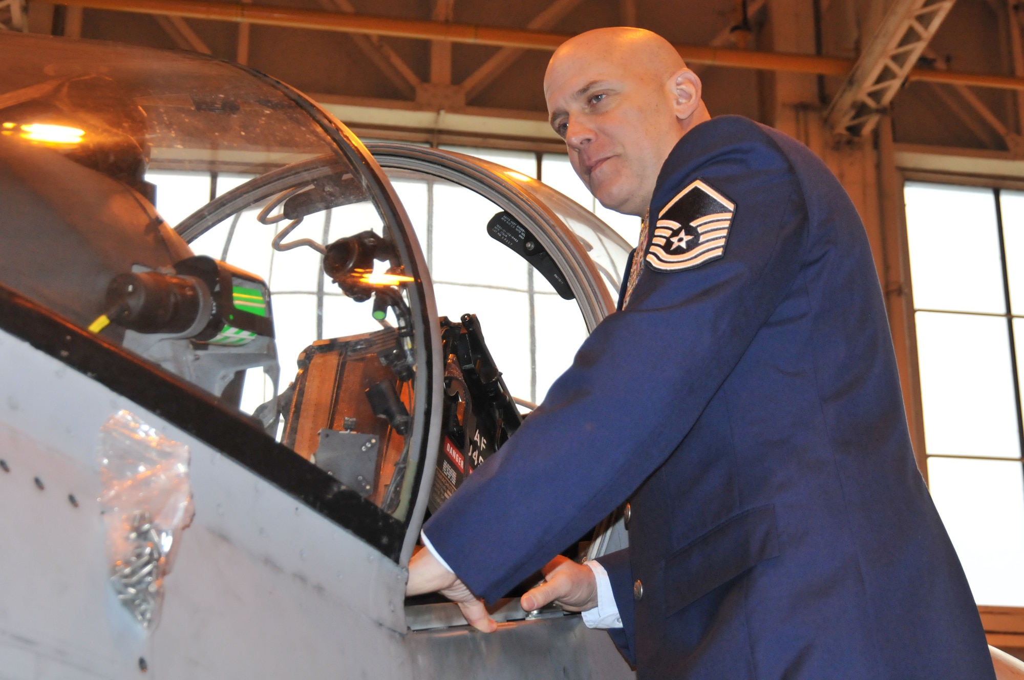 ROYAL AIR FORCE COTTESMORE, England – Master Sgt. Louis Distelzweig, a pararescueman with the 56th Rescue Squadron at RAF Lakenheath, looks in the cockpit of a Harrier jet Jan. 11. The aircraft was similar to ones his father, Capt. Louis Distelzweig Jr., flew during his time as an exchange pilot with the RAF in 1970. (U.S. Air Force photo/Senior Airman David Dobrydney)