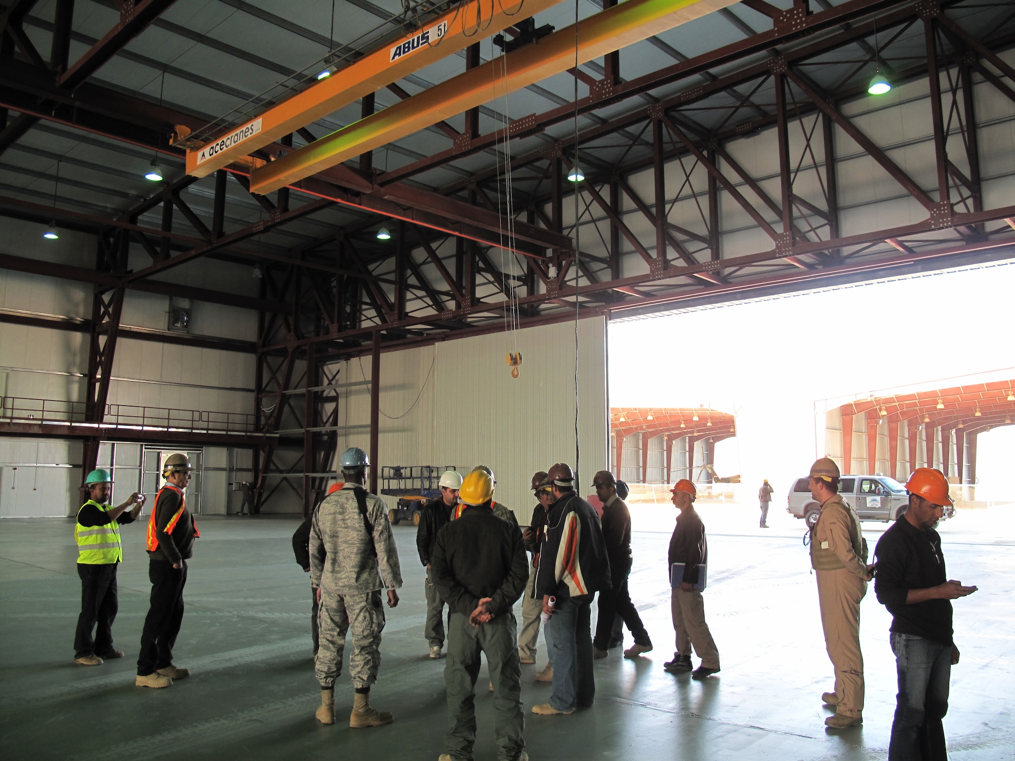 The Iraq Training and Advisory Mission-Air Force, Taji Base Transition Team does the final walk through inspection of the Mi-17 helicopter hangar at Taji Air Base with the US Army Corps of Engineers and Al-Sami, the local Iraqi construction company that built it.  At more than 240 ft long and 50 ft tall the hanger is the largest maintenance hangar in Iraq, and the largest clear-span building in the entire Middle East.  (Courtesy photo)