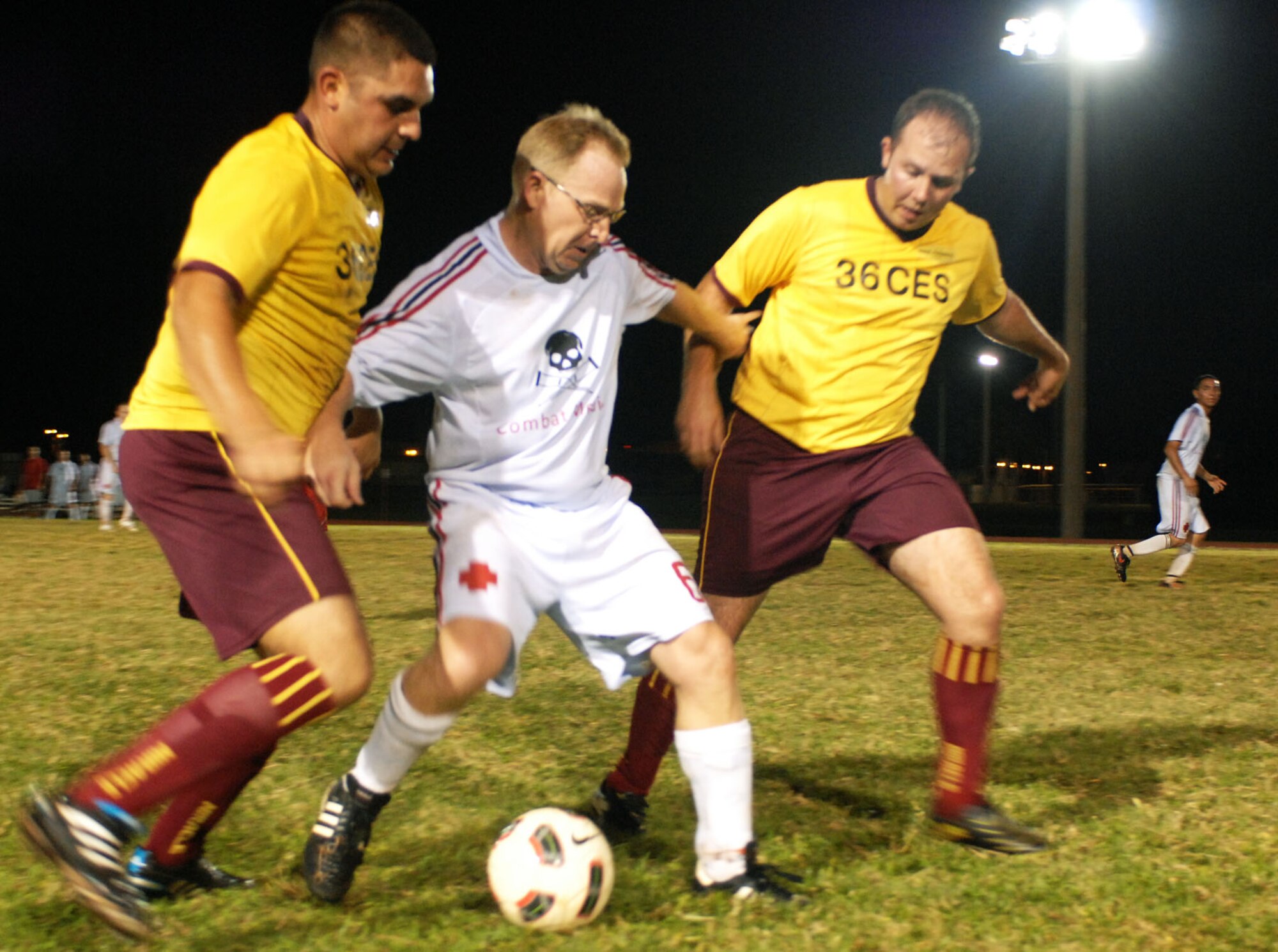 A 36th Medical Group team member defends the ball against two 36th Civil Engineer Squadron players during the 2010 Intramural Soccer Championship game, here Jan. 10. The Med Group defeated the CE team 3-1. (U.S. Air Force photo/ Airman 1st Class Anthony Jennings)
