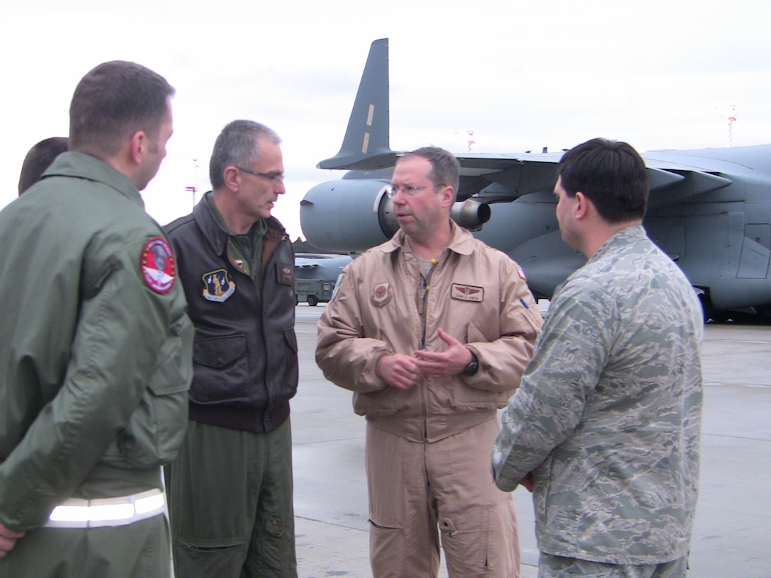 Air Force Brig. Gen. John Owen, right, a Missouri Air National Guard member who is the Air Guard advisor to the command surgeon of Air Mobility Command, talks with Air Force Col. Bruce Guerdan of the Florida Air Guard, second from left, and Master Sgt. Jody Nitz of the Michigan Air Guard, left and back to camera, after he lands at Ramstein Air Force Base, Germany, Jan. 9, 2011. Owen worked with AMC to provide the Air Guard medical personnel needed for critical care air transport teams. Guerdan and Nitz are members of the first Air Guard CCATT deployed to Ramstein. In the right foreground is Air Force Maj. Joey Jackson of the Tennessee Air Guard, an air operations officer deployed to Ramstein. U.S. Air Force photo by Lt. Col. Ellen Krenke