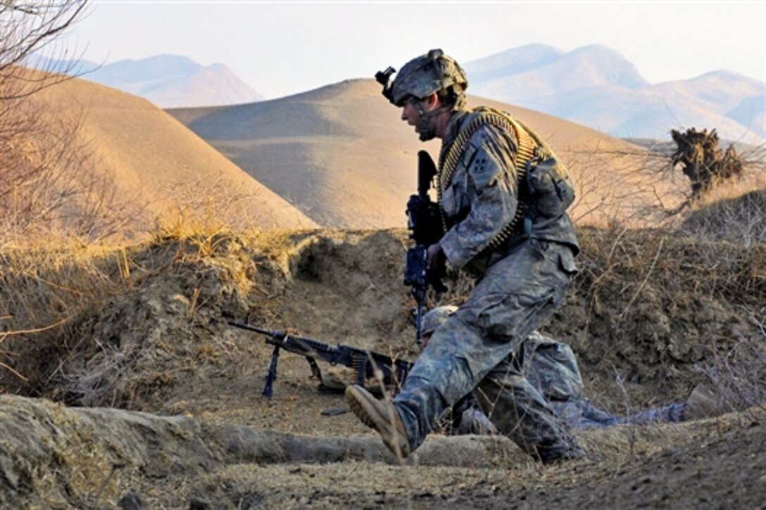U.S. Army soldiers take cover as they receive fire on a riverbed near Combat Outpost Delorean in Bala Murghab in Afghanistan's Baghdis province, Jan. 9, 2011. The soldiers are assigned to the 4th Infantry Division's 1st Brigade.