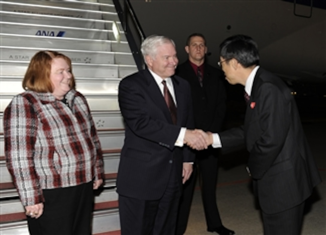 Secretary of Defense Robert M. Gates and wife Becky are greeted by the Director General of the Japanese Ministry of Foreign Affairs Umemoto on their arrival in Tokyo, Japan, on Jan. 12, 2011.  