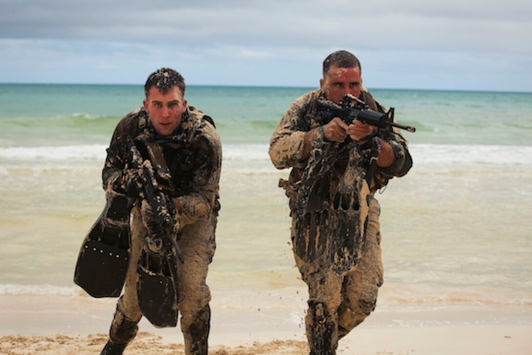 Cpl. Jonathon Schannep and Sgt. Daniel Kahn, force reconnaissance Marines with 4th Force Reconnaissance Company, scout a beachfront during hydrographic reconnaissance training at Marine Corps Training Area Bellows in Waimanalo, Hawaii, Jan. 13, 2011. The training was part of a weeklong jump and dive training package that brought the unit, headquartered in Alameda, Calif., together with their Hawaii-based counterparts â?? 4th Forceâ??s 4th platoon. Following a real-life mission, the data they collect â?? such as the size and frequency of wave crests, sediment type and slope of the beach â?? allows unit commanders to determine what type of landing and vehicles the beachâ??s composite supports, said Petty Officer 2nd Class Mike Weissman, a hospital corpsman with 2nd Platoon, 4th Force.