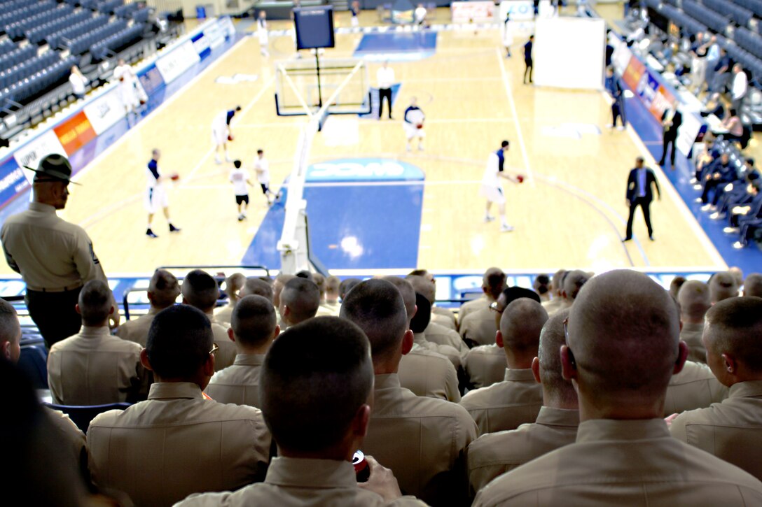 Marines from Co. L, 3rd Recruit Training Battalion, watch as the University of San Diego Toreros prepare for their game against the Santa Clara University Broncos at the Jenny Craig Pavilion, Jan. 13.