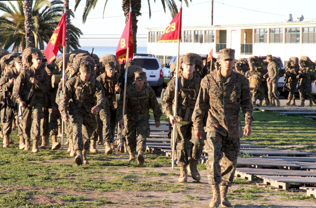 The new Marines of Co. B finish strong as they complete the last few feet of the Reaper hike to the parade deck. The Reaper hike is the last obstacle they must face before they are handed their eagle, globe, and anchor emblems.