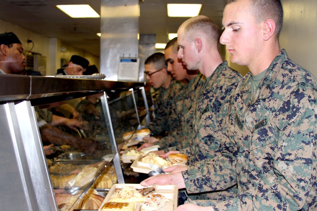 Platoon 1033 loads their trays at their Warrior’s Breakfast after completing the Crucible. The breakfast is their first meal as Marines.
