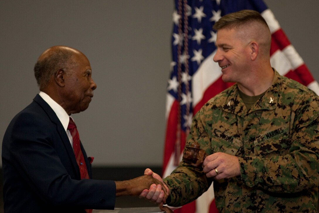 Col. Alan L. Thoma (right), Headquarters and Service Battalion commander, U.S. Marine Corps Forces, Pacific, presents Ernest Golden, vice chairman of the African American Diversity Cultural Center of Hawaii, with a gift for serving as the guest speaker for MarForPac and U.S. Pacific Command’s Martin Luther King, Jr., Day observance Jan. 14 here.::r::::n::During the event, Golden shared what is was like growing up as a young black man in America when segregation was the law of the land, witnessing King’s civil rights movement and the positive change it made for every American, black, white or otherwise.