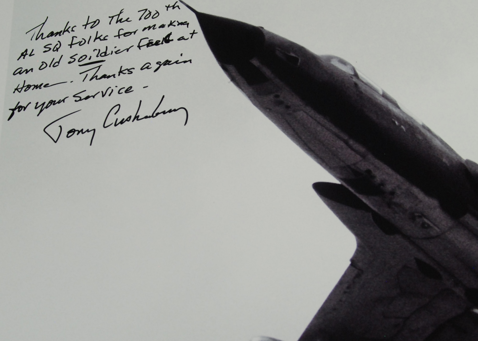 Retired Col. “Tony” Cushenberry’s autographed poster of a Vietnam War era F-105 Thunderchief  thanks the 700th Airlift Squadron for their hospitality and service Jan. 9.   (U.S. Air Force photo/Master Sgt. Stan Coleman) 