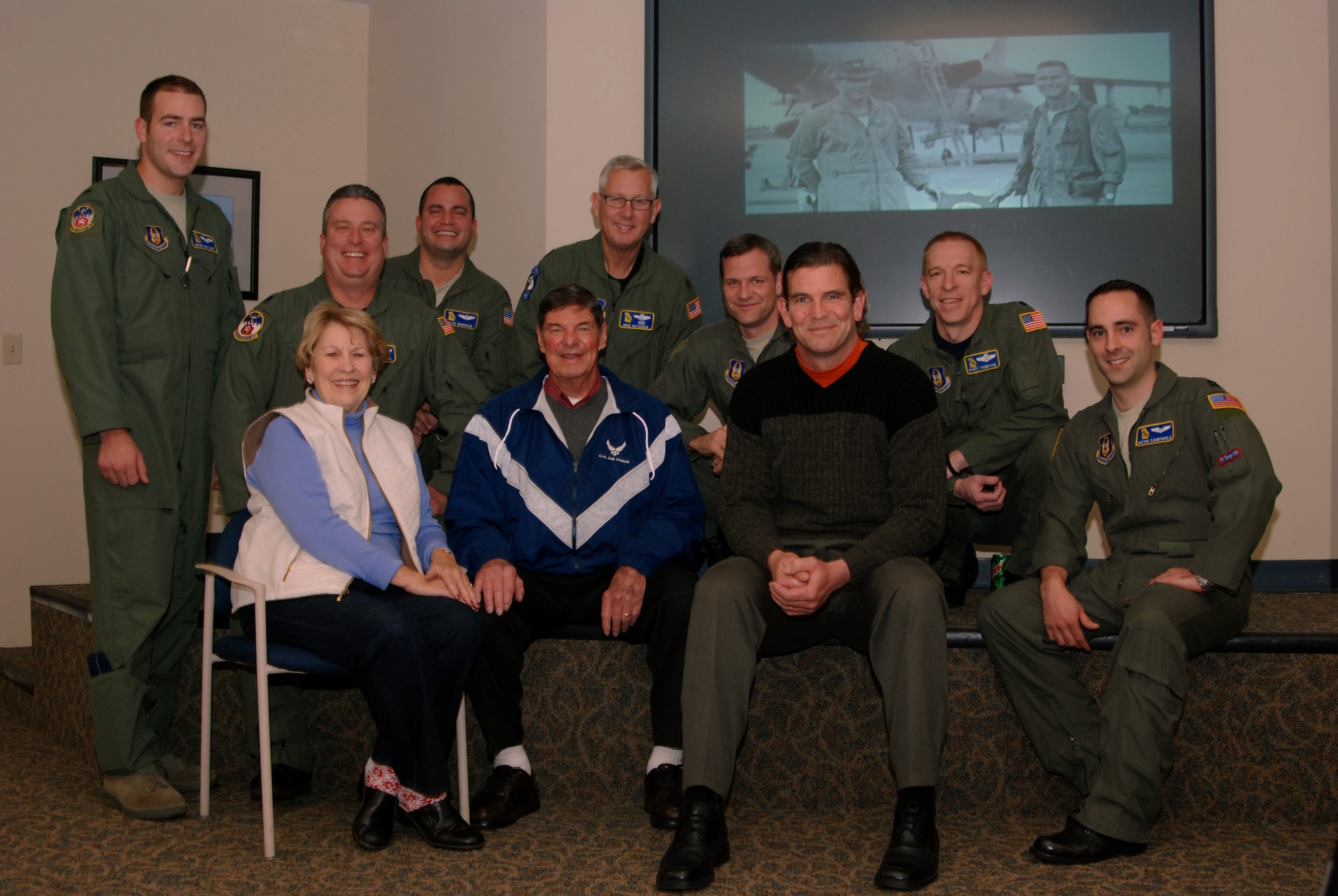 Retired Col. “Tony” Cushenberry, his wife, Marie and his son, Chris, celebrate the colonel’s Air Warrior briefing on his combat experiences in Vietnam with a group photograph with 700th Airlift Squadron aviators Jan 9.  Colonel Cushenberry is a Georgia Aviation Hall of Fame pilot who is noted for the 125 combat missions he flew during the Vietnam War.  (U.S. Air Force photo/Master Sgt. Stan Coleman)  