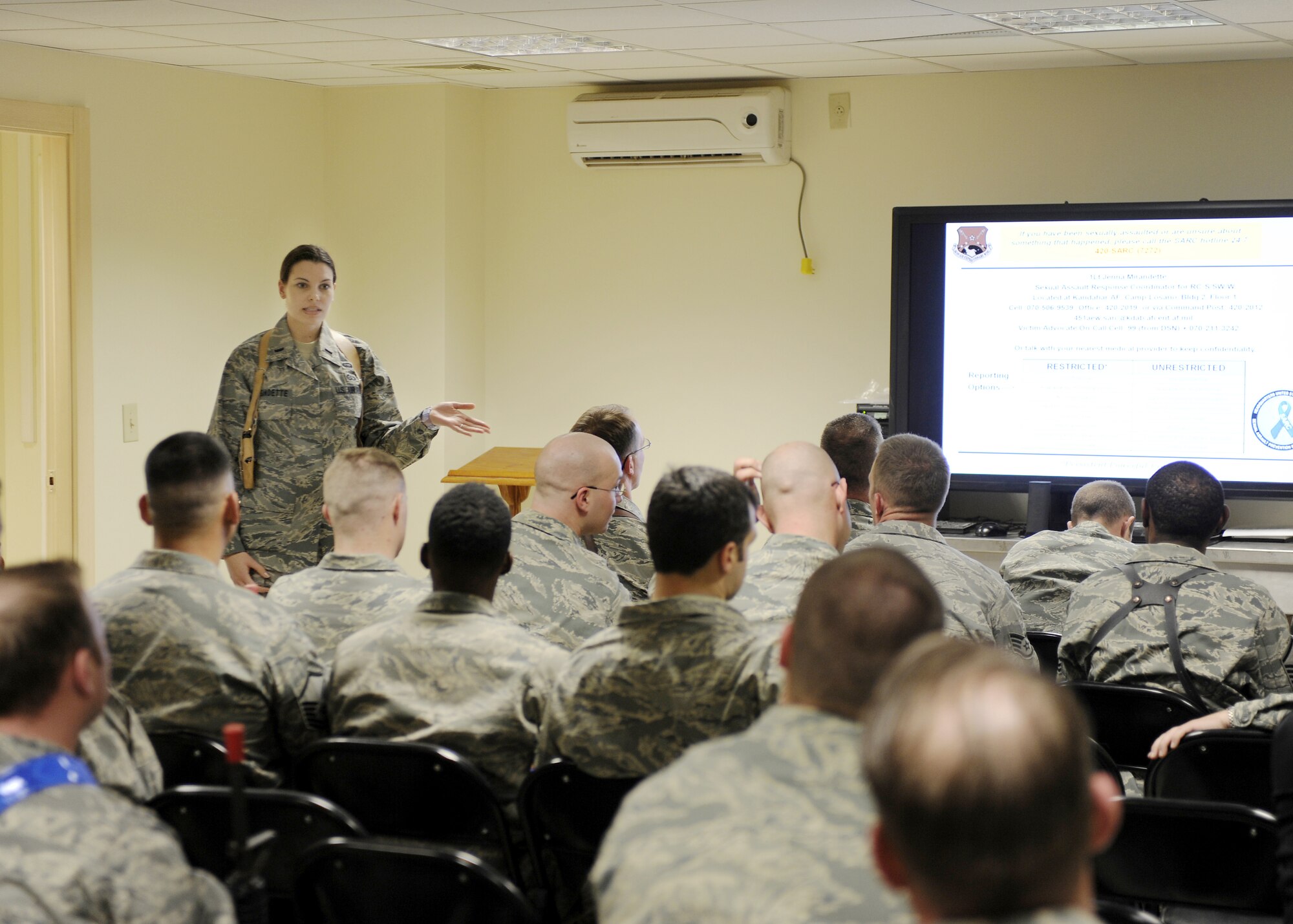 First Lt. Jenna Mirandette gives a brief during an orientation, Jan. 13,
2011, at Kandahar Airfield, Afghanistan. Lieutenant Mirandette is the sexual
assault response coordinator assigned to the 451st Air Expeditionary Wing.
She is one of two Air Force SARCs in Afghanistan and supports military
members under Regional Commands South, Southwest, and West in southern Afghanistan. (U.S. Air Force photo/Senior Airman Willard E. Grande II)
