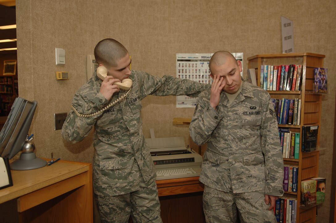 Airman 1st Class Terry Nartowicz, Air Force Financial Services Center reserve travel technician, demonstrates the last step of the Air Force suicide prevention ACE (Ask, Care and Escort) model by escorting Senior Airman Casey Rodriguez, AFFSC temporary duty support finance technician, to speak with someone trained to help him at Ellsworth Air Force Base, S.D., Jan. 12. (U.S. Air Force photo/Airman 1st Class Alessandra N. Hurley)
