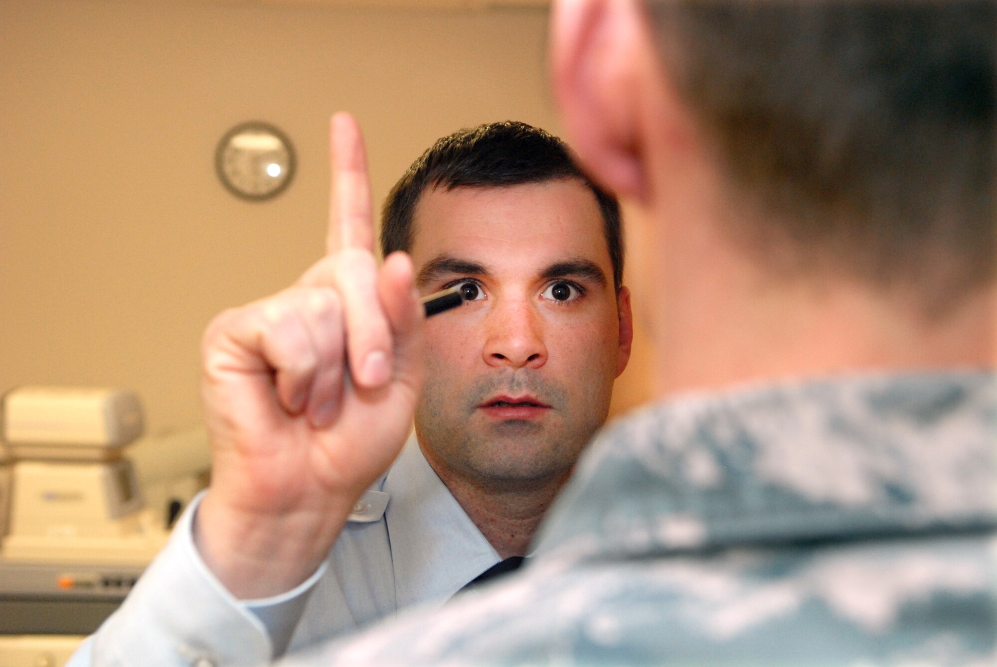 Tech. Sgt. Edward Mayle uses his finger to check how well a patient's eyes track movement during an appointment in the optometry clinic on Monday, January 10, 2011, in the optometry clinic of the 90th Medical Group.  Mayle was named the Ophthalmic Noncommissioned Officer of the Year by Air Force Global Strike Command. (U.S. Air Force photo by R.J. Oriez)
