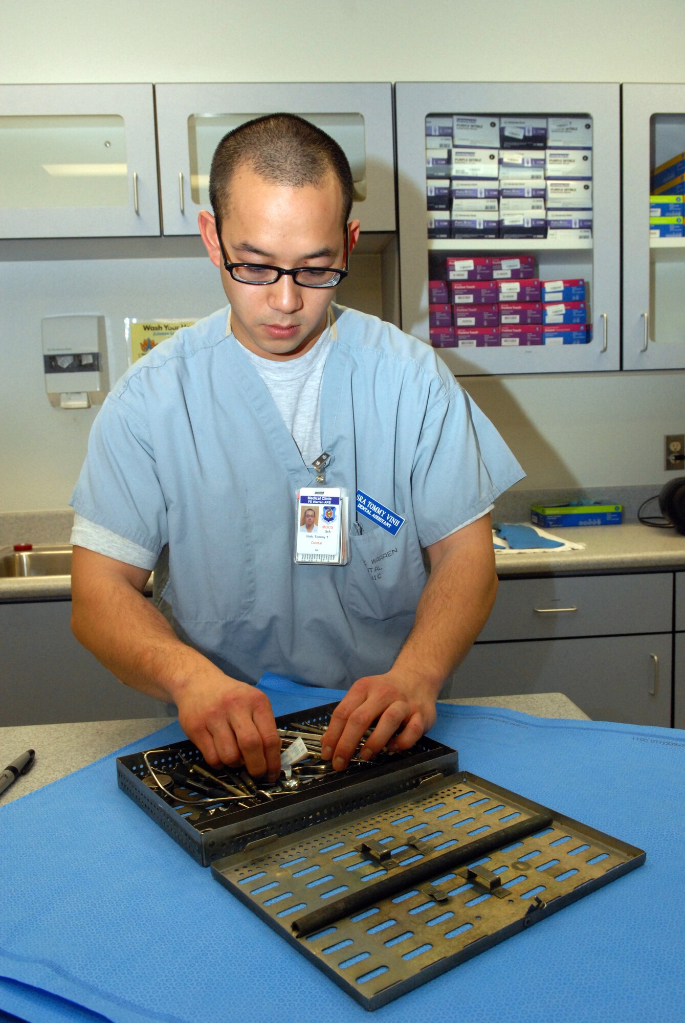 Senior Airman Tommy Vinh prepares a set of dental instruments for sterilization after it came out of the chemical disinfectant washer at the 90th Medical Group here Monday, January 11, 2011. Vinh, a native of Ft. Smith, Ark., was named the Global Strike Command Dental Airman of the Year. (U.S. Air Force photo by R.J. Oriez)

