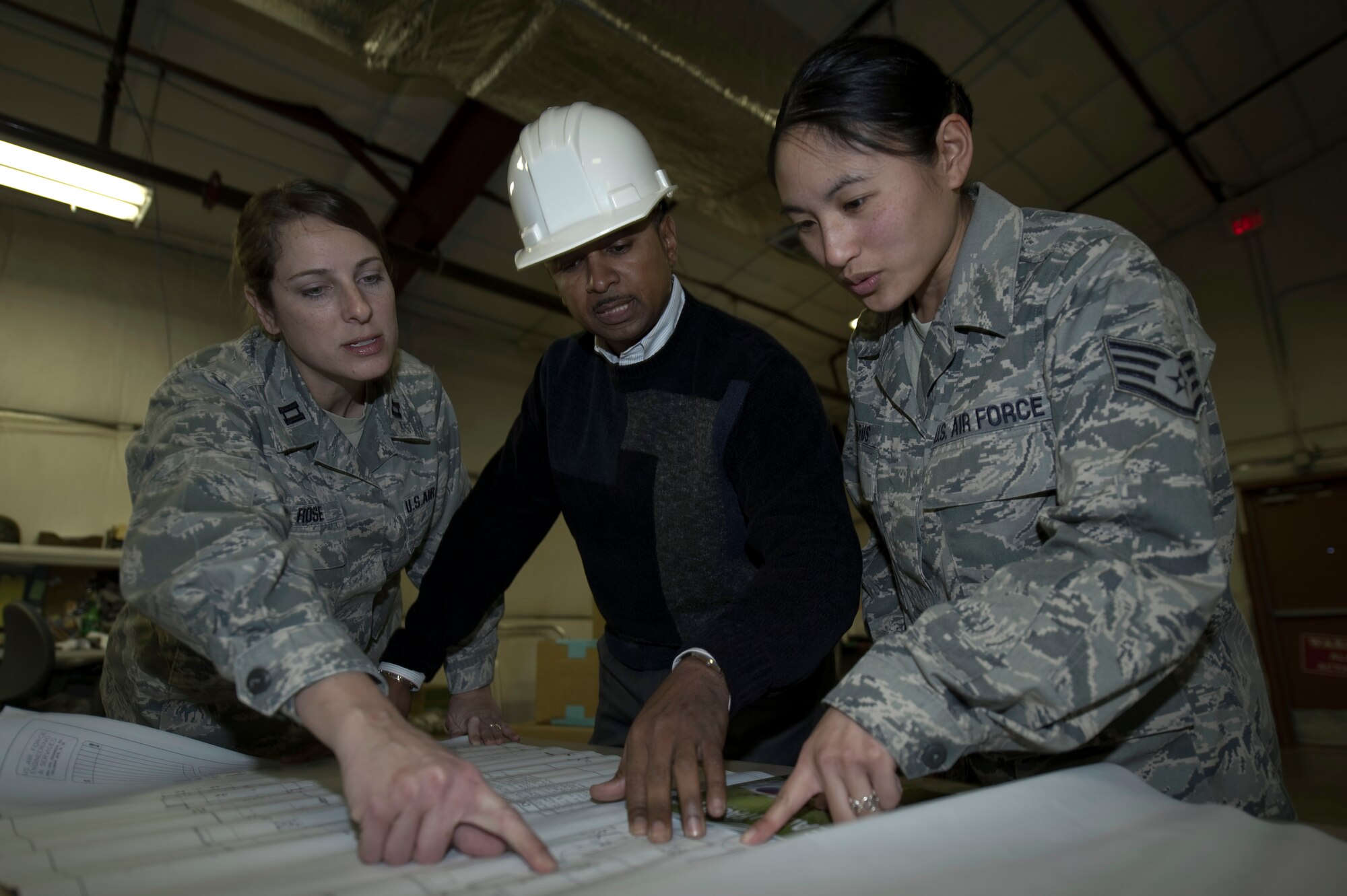 HOLLOMAN AIR FORCE BASE, N.M. -- Capt. Dawn Rose, Mr. Maurice Lopez and Staff Sgt. Zsa Zsa Corpus, all with the 49th Medical Support Squadron, review renovation plans Jan. 13, 2011. Captain Rose was named the Outstanding Medical Logistics Company Grade Officer of the year for 2010 by Air Combat Command and Air Force Medical Service. (U.S. Air Force photo by Airman 1st Class Joshua Turner/Released)