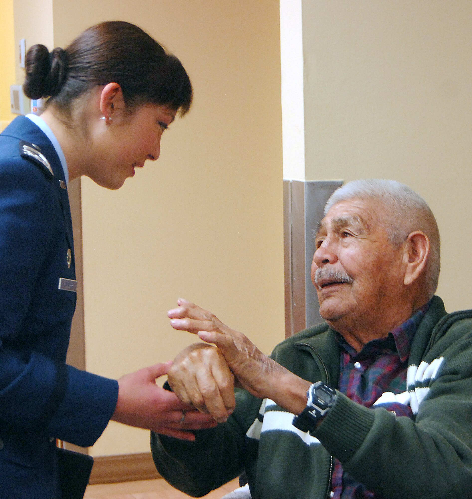 Cadet 2nd Class Paulina Rudolph speaks with a Navajo code talker at the Veterans Administration hospital in Phoenix Jan. 9, 2011. Cadet Rudolph, a member of the Air Force Academy Cadet Chorale, is assigned to Cadet Squadron 06. The Chorale traveled to Arizona to sing the national anthem for the BCS national championship. (U.S. Air Force photo/2nd Lt. Meredith Kirchoff)