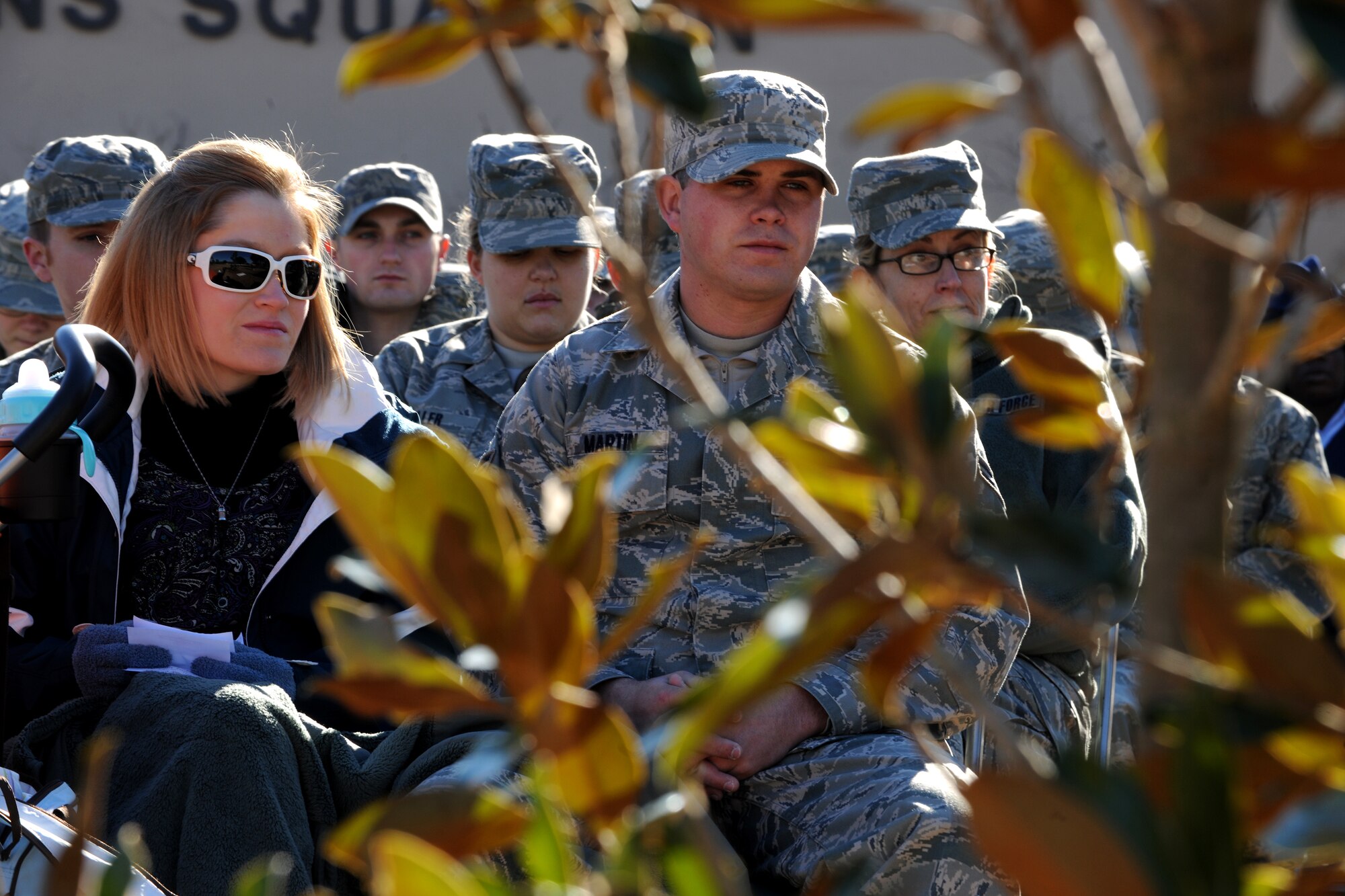 MOODY AIR FORCE BASE, Ga.-- Airman 1st Class Simon Martin and wife, Valerie, sit in the front row during a tree dedication ceremony for their deceased son, Karson Thomas Martin, Jan. 14. Even though Airman Martin has changed duty stations, he and his family were able to make the trip back to Moody to witness the tree dedication. (U.S. Air Force photo/Airman 1st Class Benjamin Wiseman)(RELEASED)