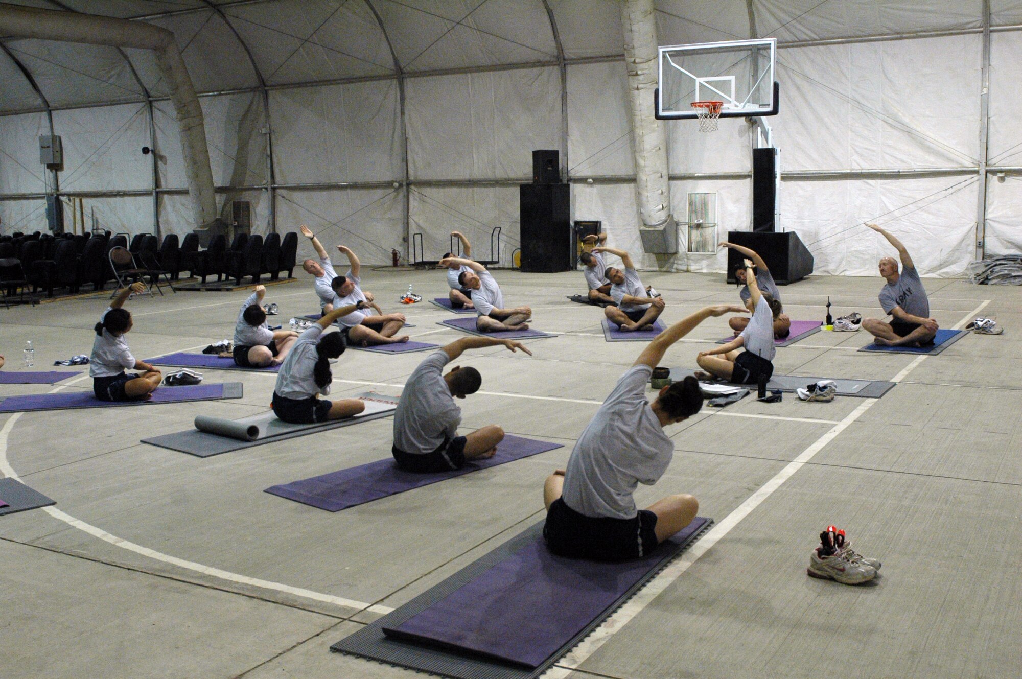 Ch. (Maj.) Christine Blice-Baum leads a yoga session while deployed to Iraq in early 2010. Upon return from her deployment, she spent 200 semester hours completing her certification to teach yoga. She now carries the titles of doctor, chaplain, major, misses, and (registered yoga teacher) RYT200, depending on what role she fills at any given time. (U.S. Air Force photo/Staff Sgt. Carolyn Viss)
