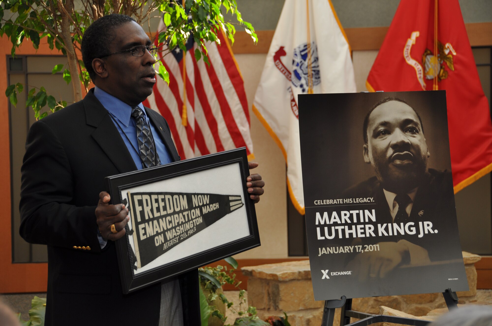 Guest speaker, Retired Ch. (Lt. Col.) Ted Henderson, shows the audience at a Dr. Martin Luther King, Jr., Commemoration Service, an important part of civil rights history which he got from his wife Beverly.  Her aunt attended Howard University. Chaplain Henderson stressed the impact Dr. King had on breaking barriers and tearing down walls. He encouraged Americans to continue that legacy so that there may be a day where there won't be African-Americans, but only Americans. (U.S. Air Force photo/Christin Michaud)