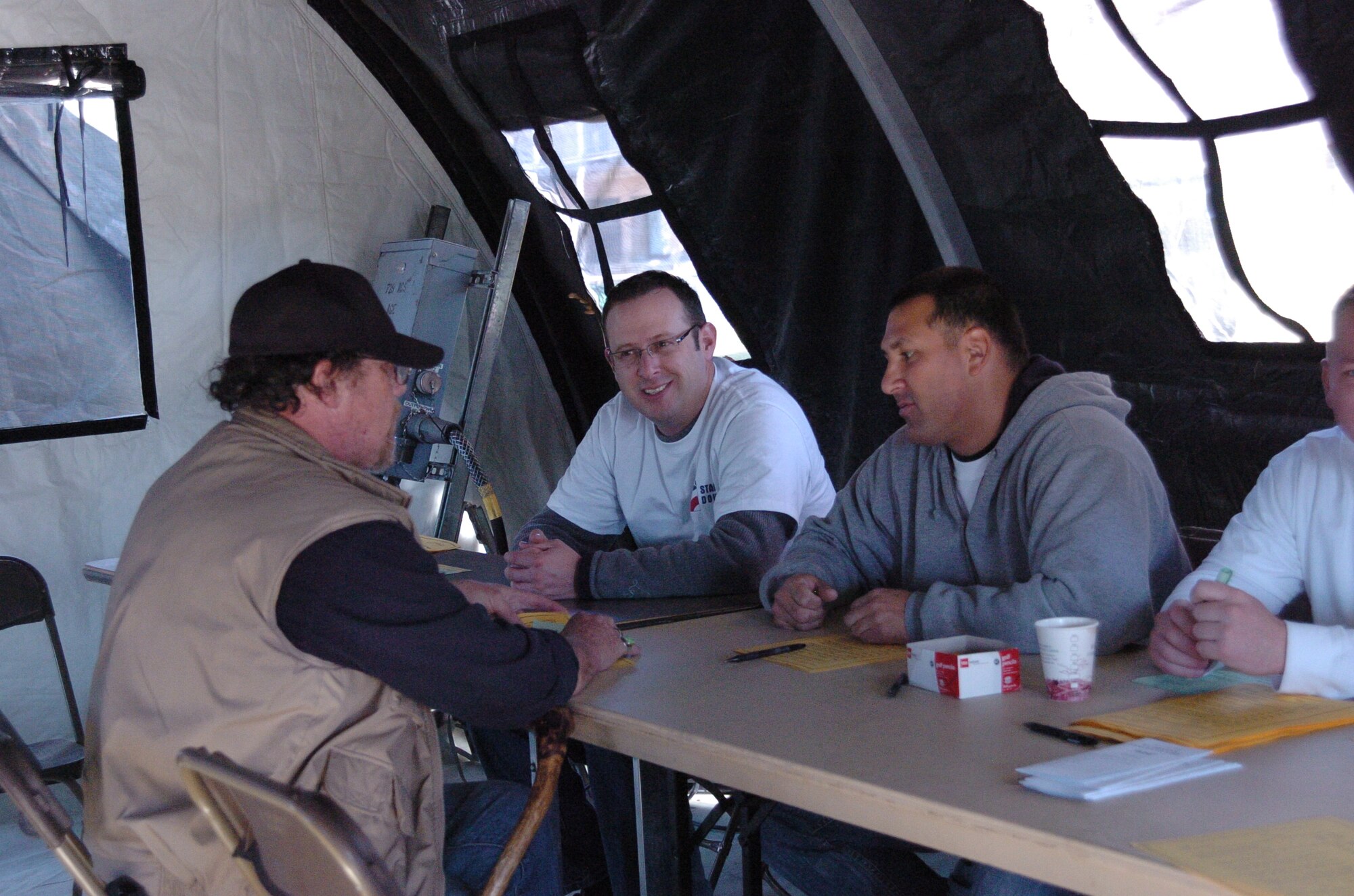 Master Sgt. Richard Magoni and Tech. Sgt. Eric Malicki, both from the 388th Maintenance Operations Squadron, volunteer at the registration tent during the Stand Down. Team Hill had approximately 150 volunteers that helped throughout the day at the event. (U.S. Air Force photo by Airman 1st Class Melissa Dearstone)