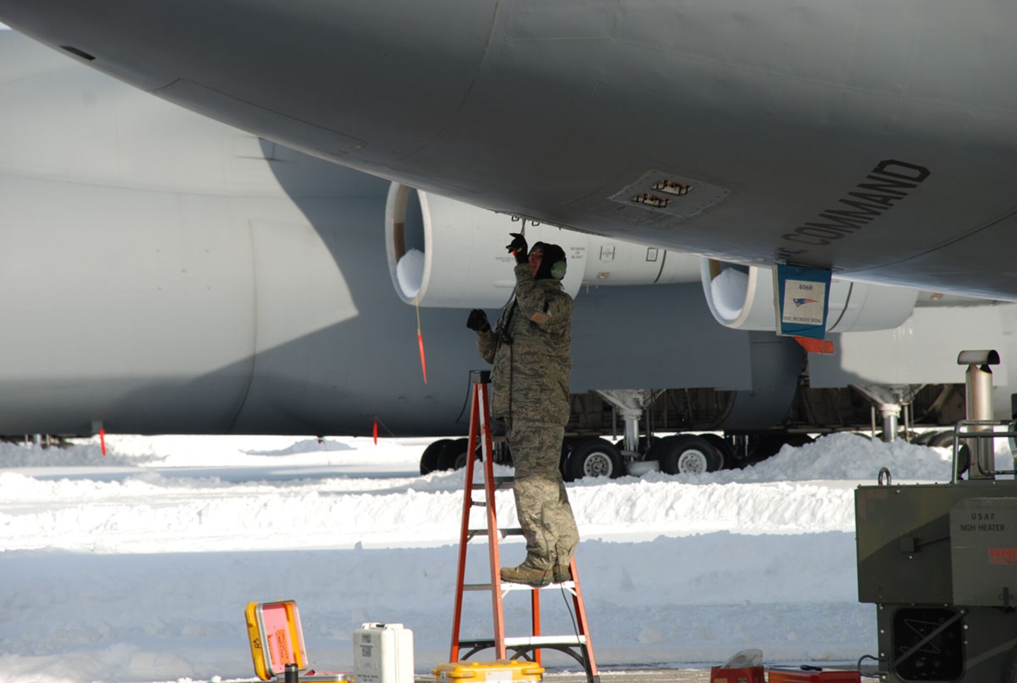 Senior Airman XXXXXX 439th Aircraft Maintenance Squadron crew chief, works on a C-5B Galaxy on the flight line Jan. 14. (US Air Force photo/Master Sgt. Andrew Biscoe)