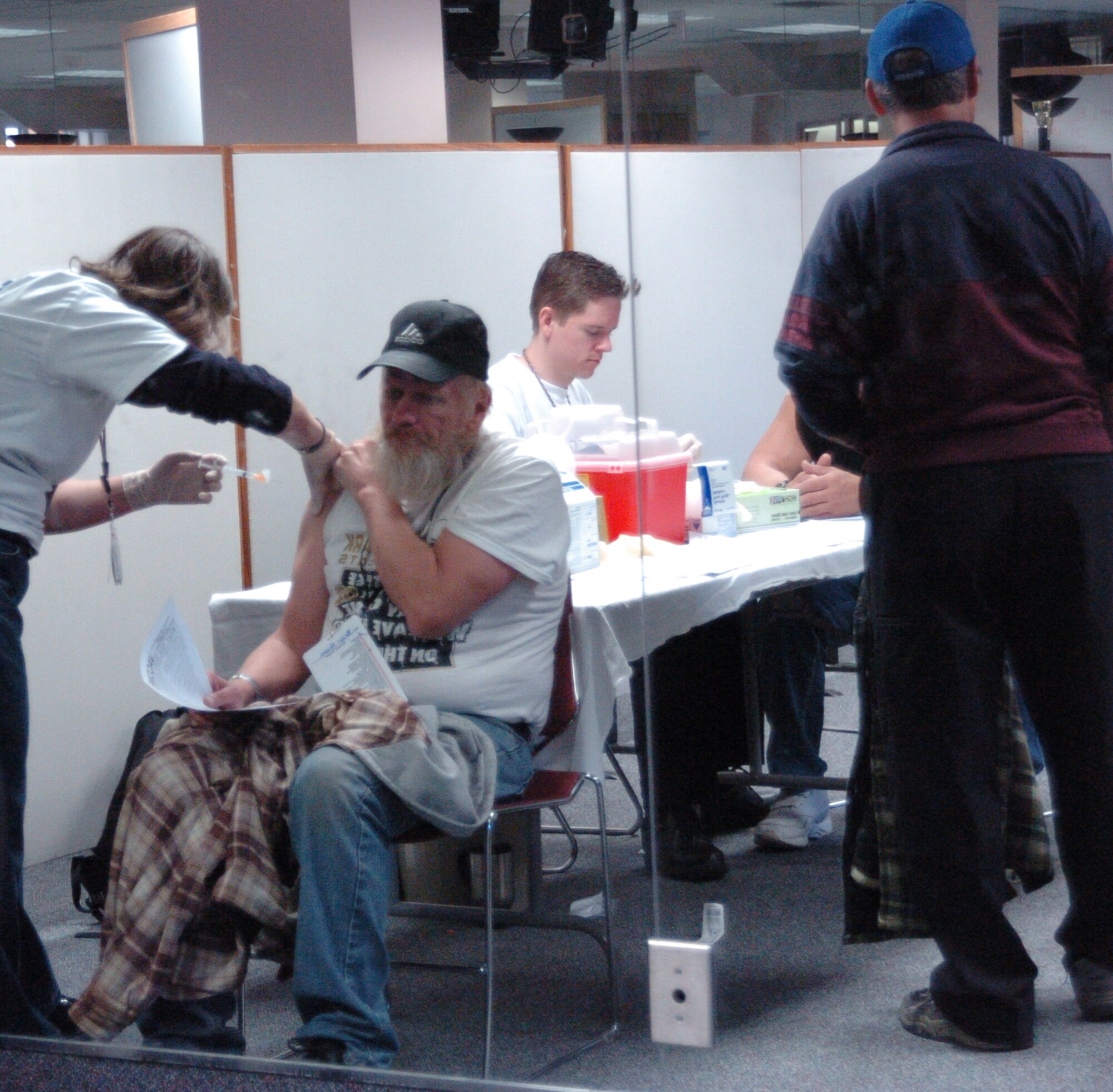 Alisha Hugh-Stricklit, nurse, administers immunizations to a verteran. The Stand Down offered medical, dental, audiology and many other Veterans Affairs booths to help the homeless vets of Salt Lake City. (U.S. Air Force photo by Airman 1st Class Melissa Dearstone)