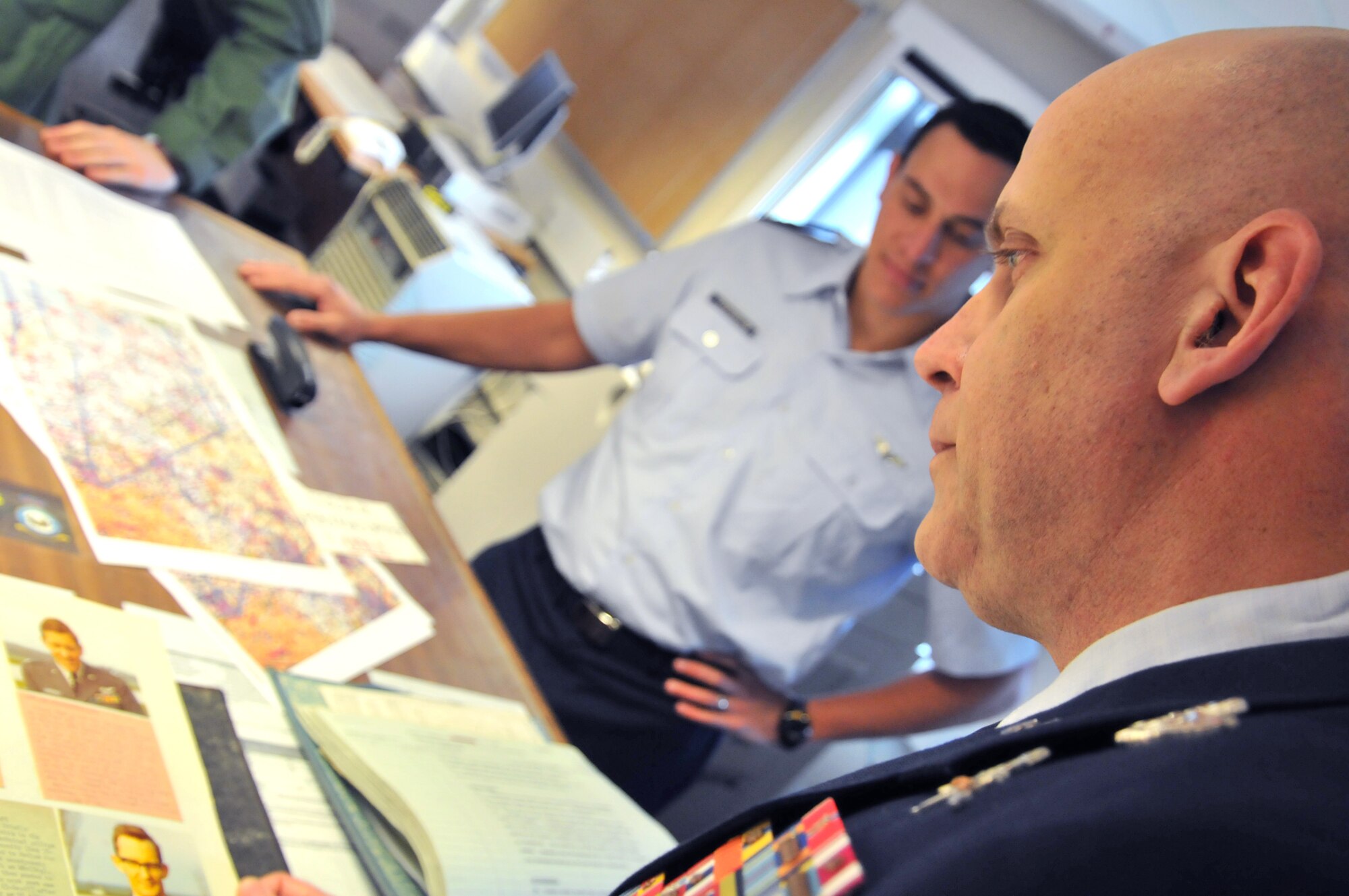 Master Sgt. Louis Distelsweig looks at a picture of his father, Capt. Louis Distelsweig Jr., in an album at  No. 1 Squadron Jan. 11, 2011, at Royal Air Force Cottesmore, England. Sergeant Distelsweig visited RAF Cottesmore to view the Harrier aircraft his father flew in the 1970 as an exchange pilot.  Sergeant Distelweig is a pararescueman with the 56th Rescue Squadron at RAF Lakenheath. (U.S. Air Force photo/Senior Airman David Dobrydney)
